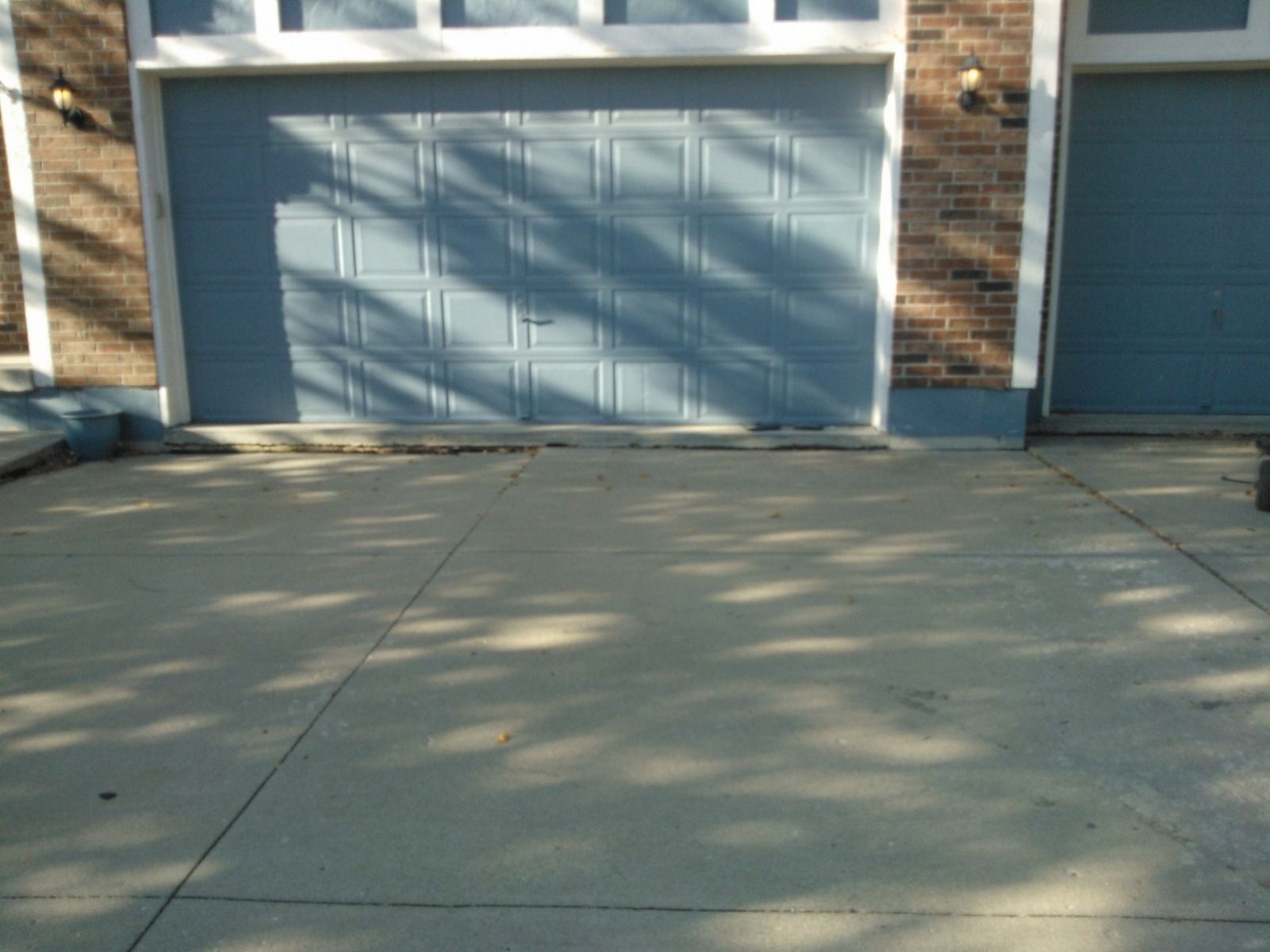 A brick house with a blue garage door