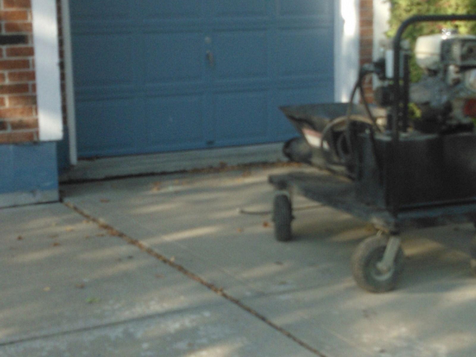 A cart is parked in front of a blue garage door