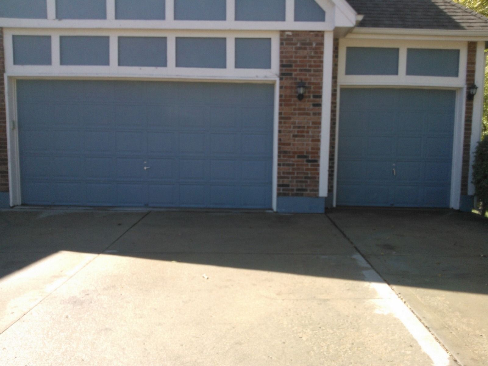 A house with two blue garage doors and a white trim