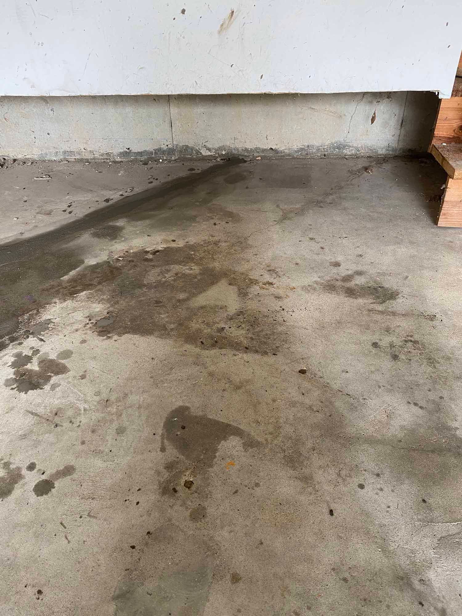 A close up of a dirty concrete floor in a garage.