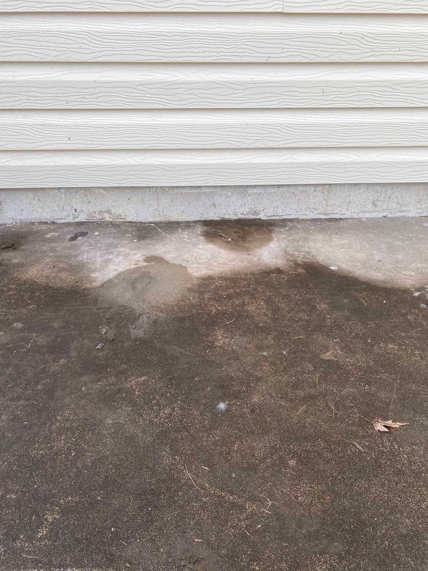 A close up of a concrete floor next to a house.