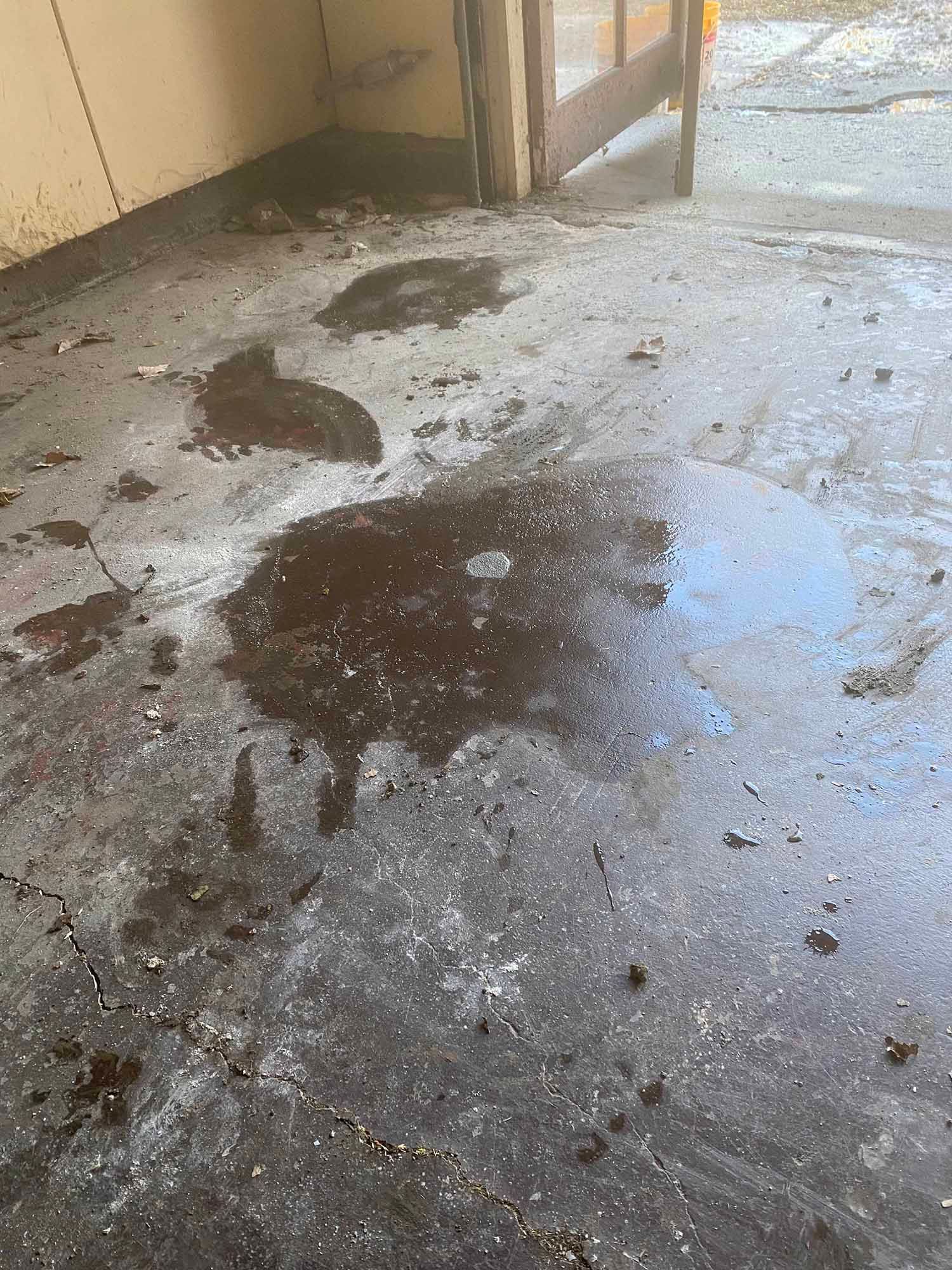 A dirty floor with a lot of stains on it.