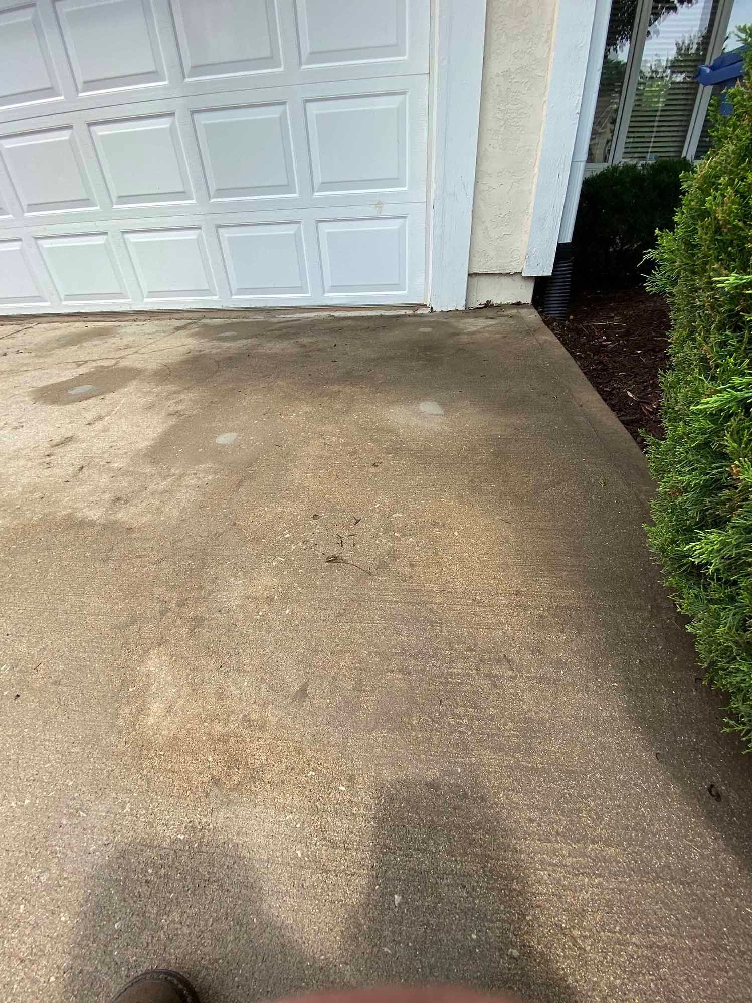 A person is standing in front of a garage door.