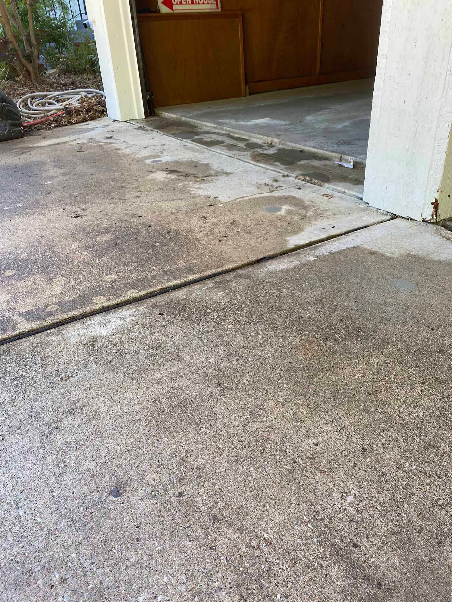 A dirty concrete floor next to a garage door.