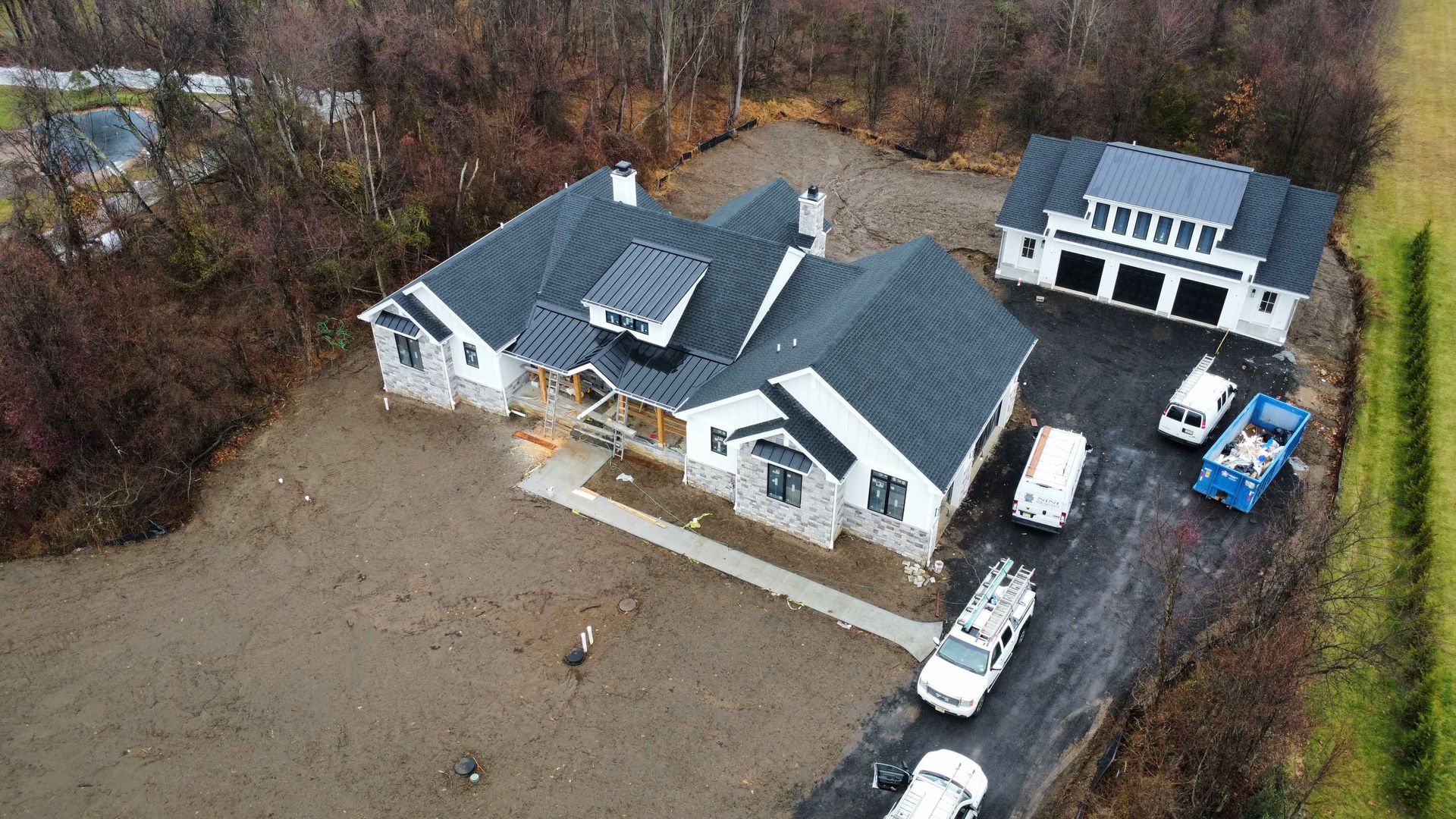 An aerial view of a house under construction with a lot of cars parked in front of it.