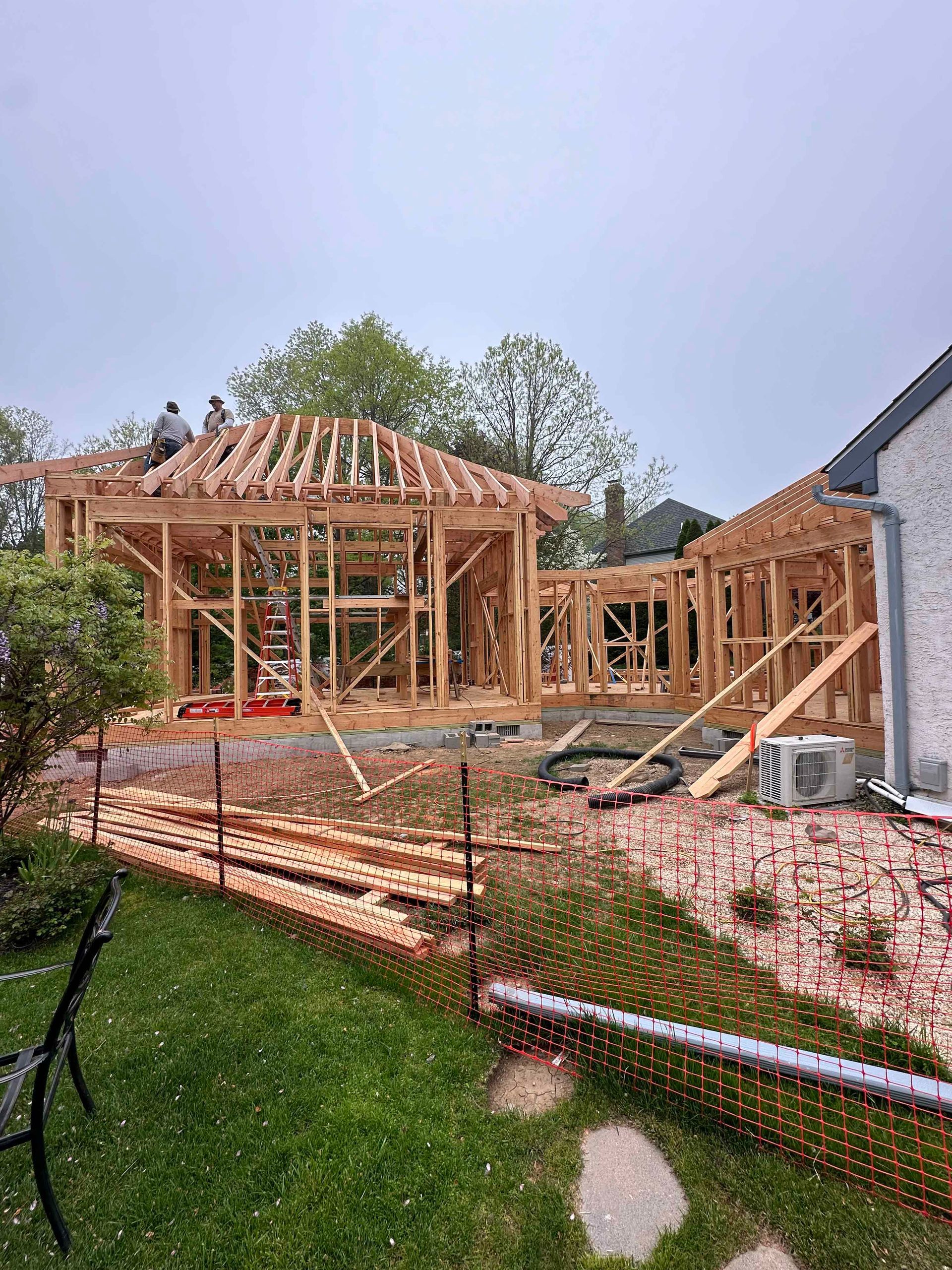 A house is being built in the backyard of a house.