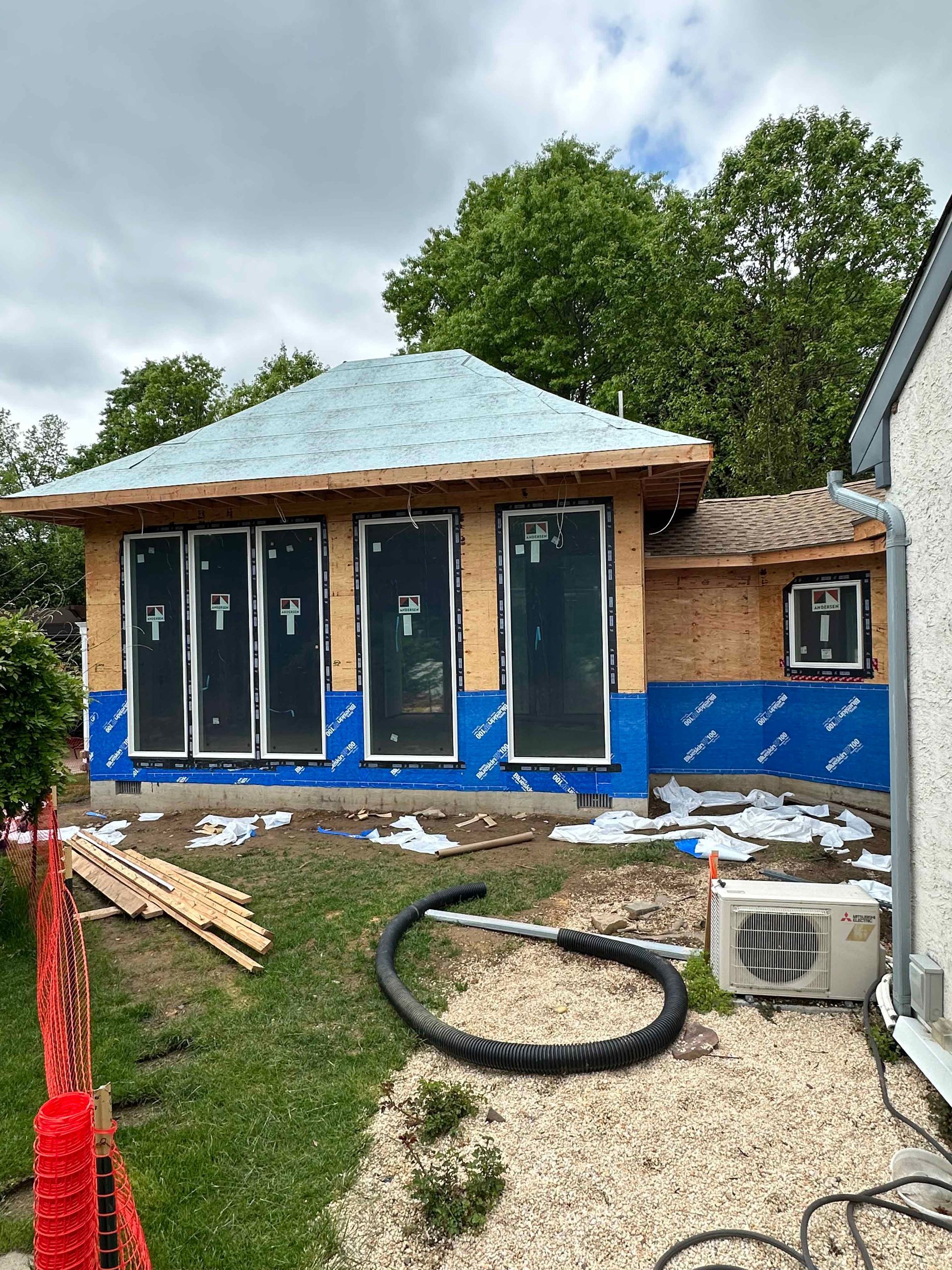 A house is being built in the backyard of a house.