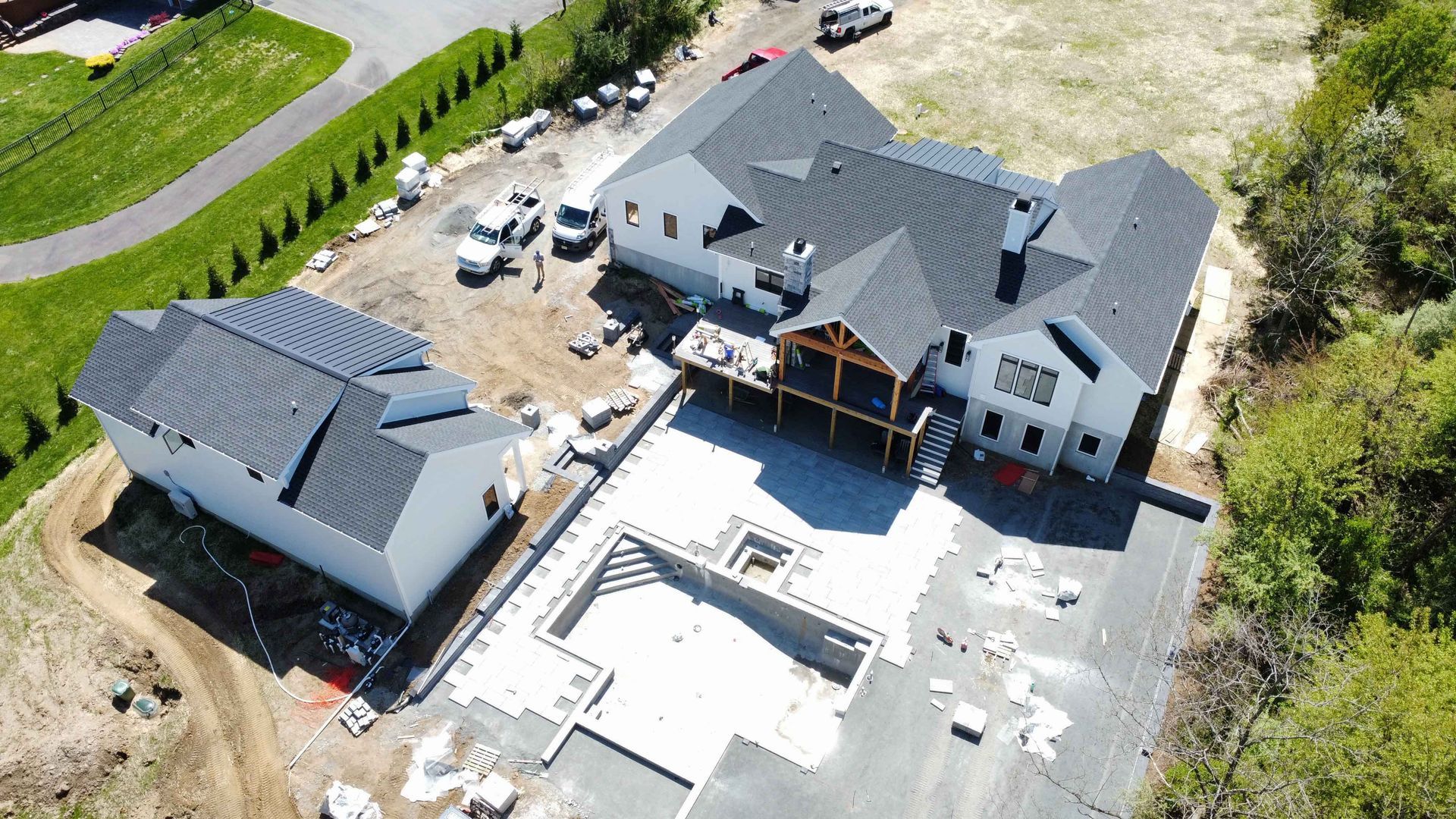 An aerial view of a house under construction with a pool