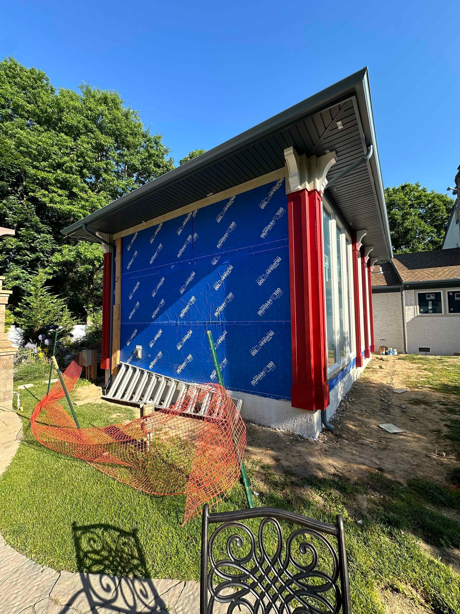A shed is being built in the backyard of a house.