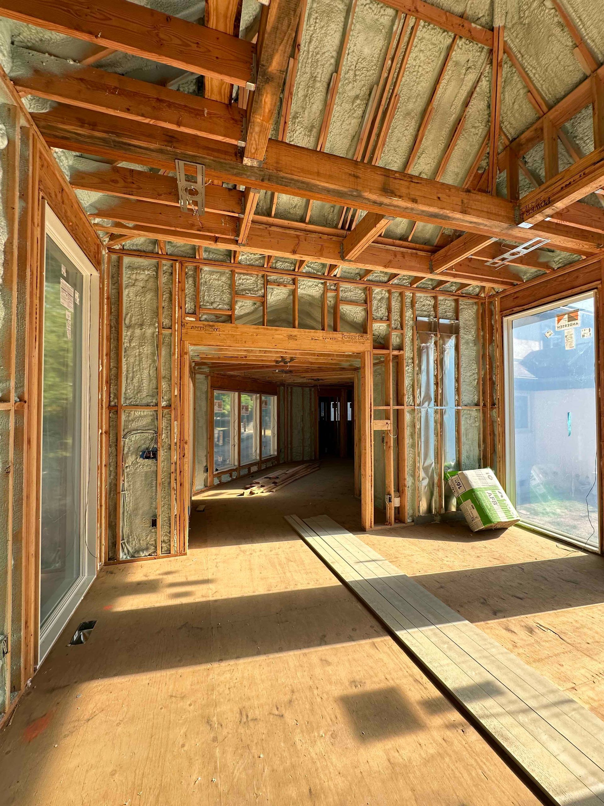 The inside of a house under construction with a lot of windows.
