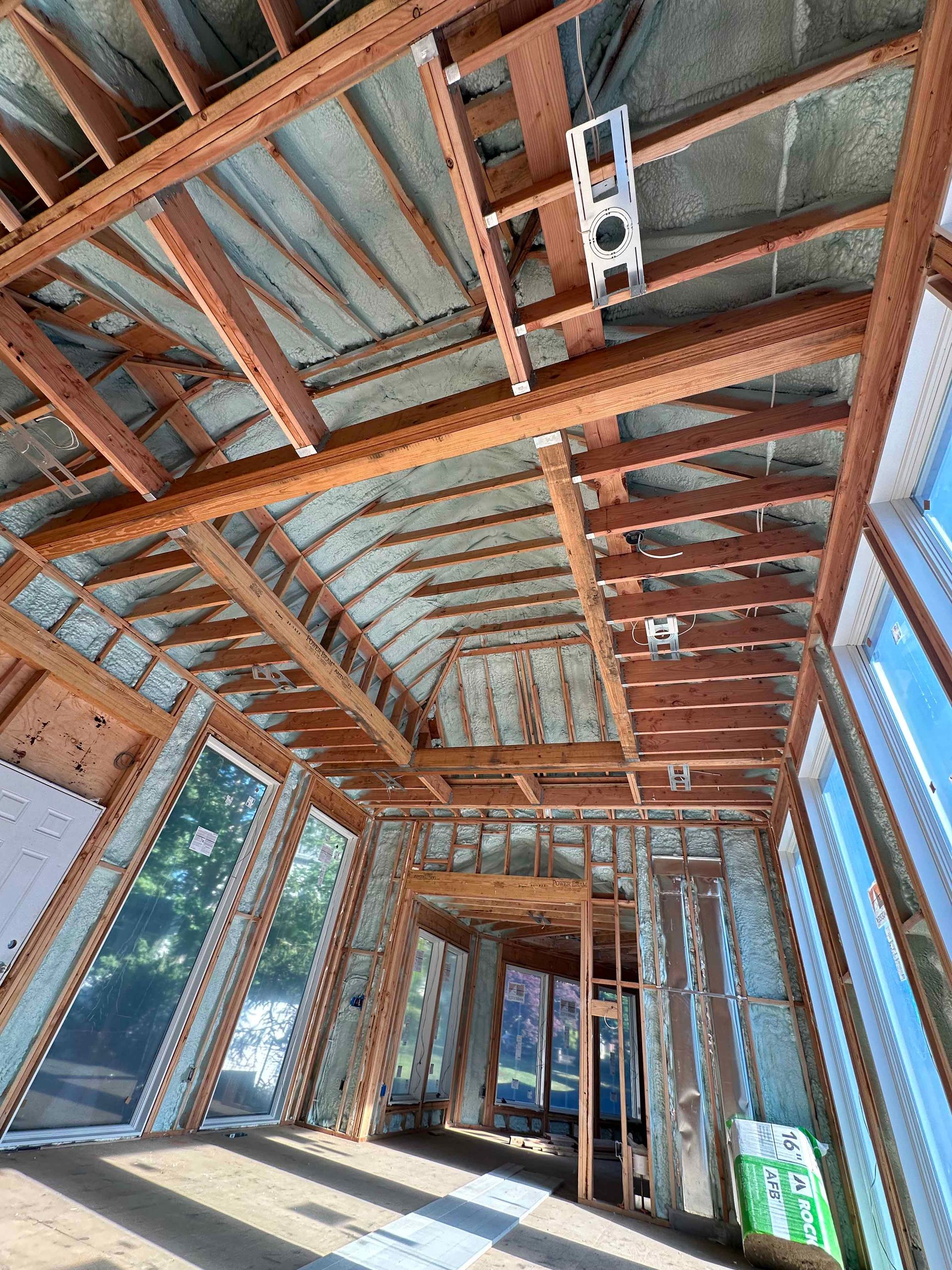 The inside of a building under construction with a lot of windows.