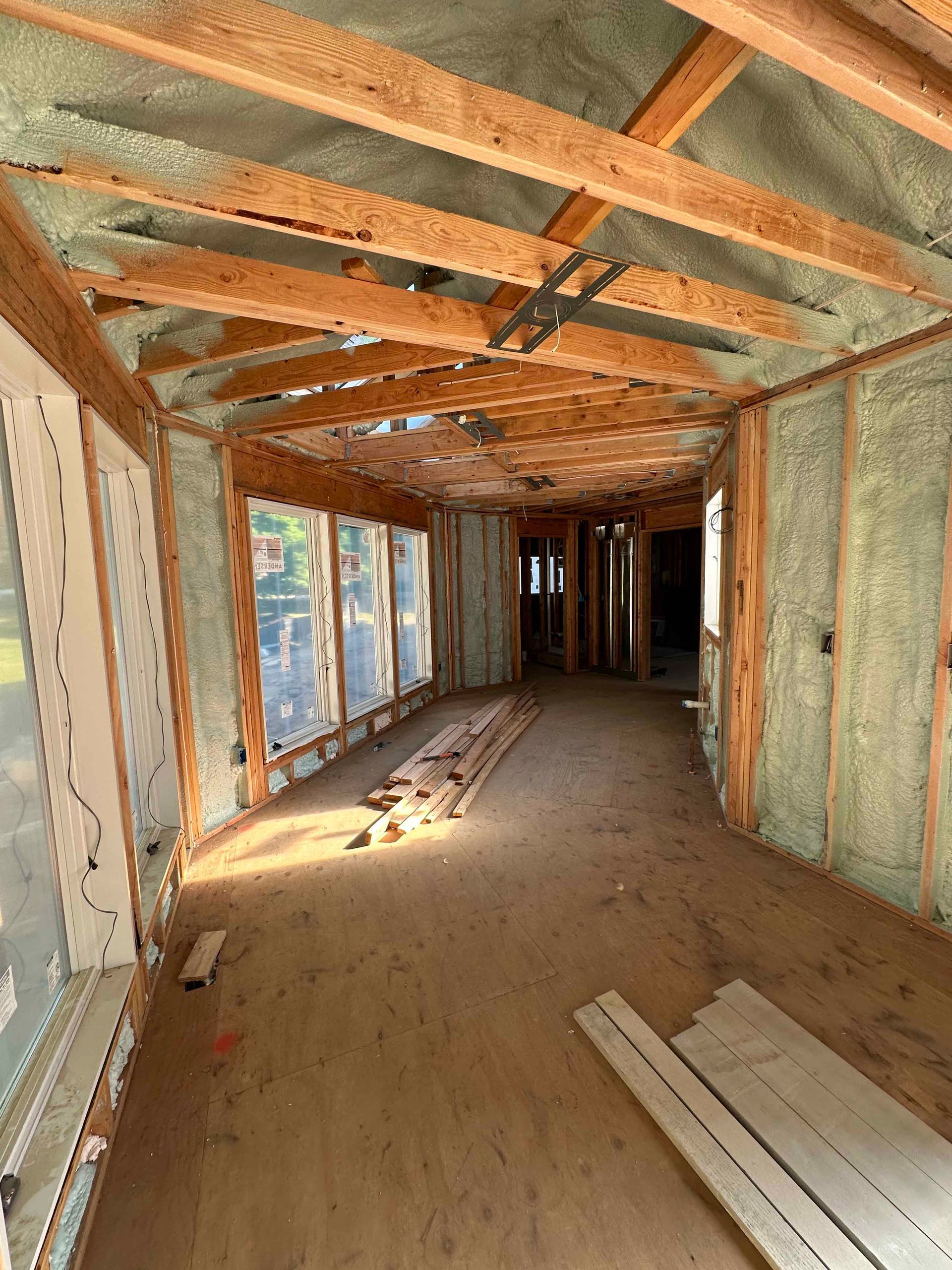 A large room with a lot of windows is being built.