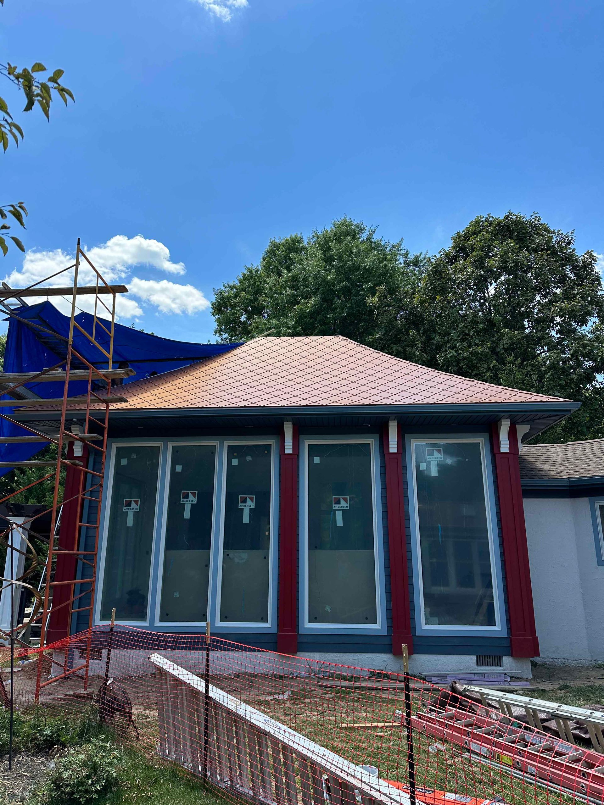 A house with a roof that is being built and a lot of windows.
