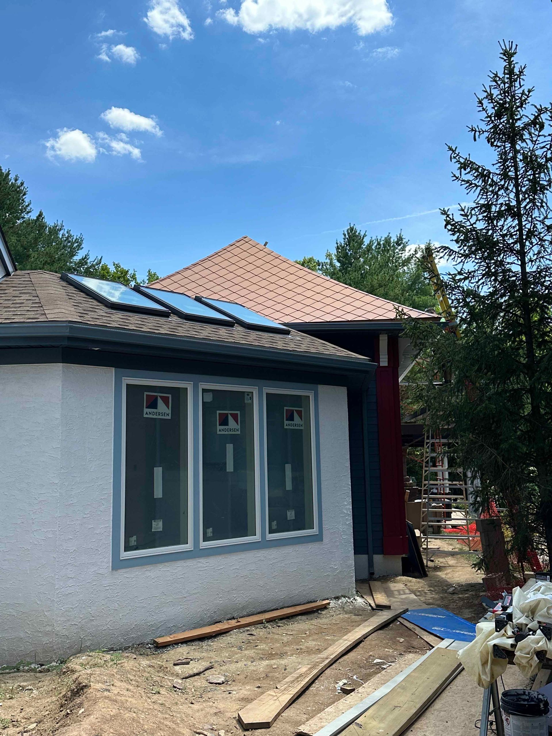 A house is being built with a roof that has solar panels on it.