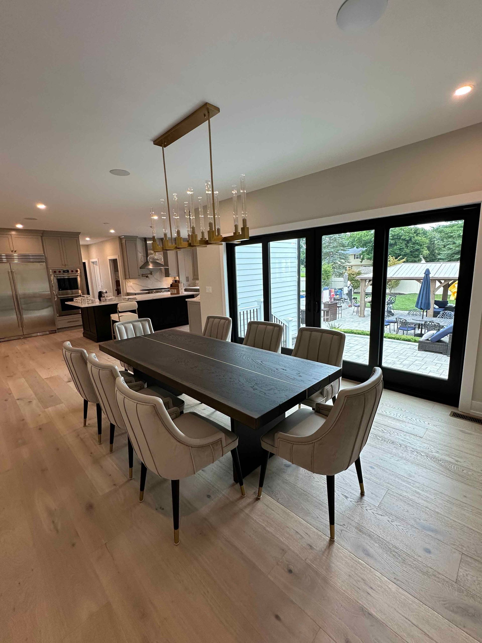 A dining room with a table and chairs and a chandelier.