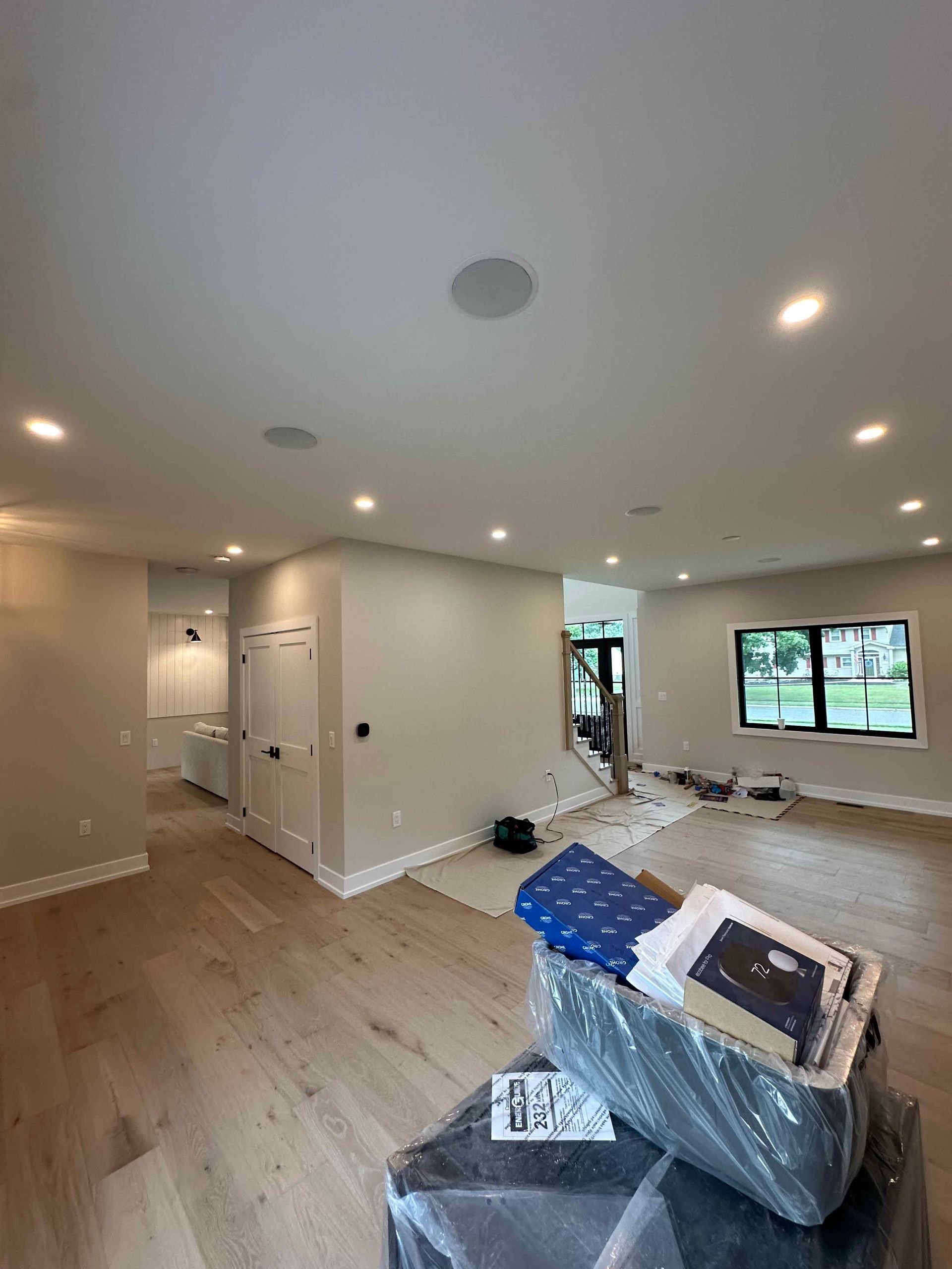 A living room with hardwood floors and white walls is being remodeled.