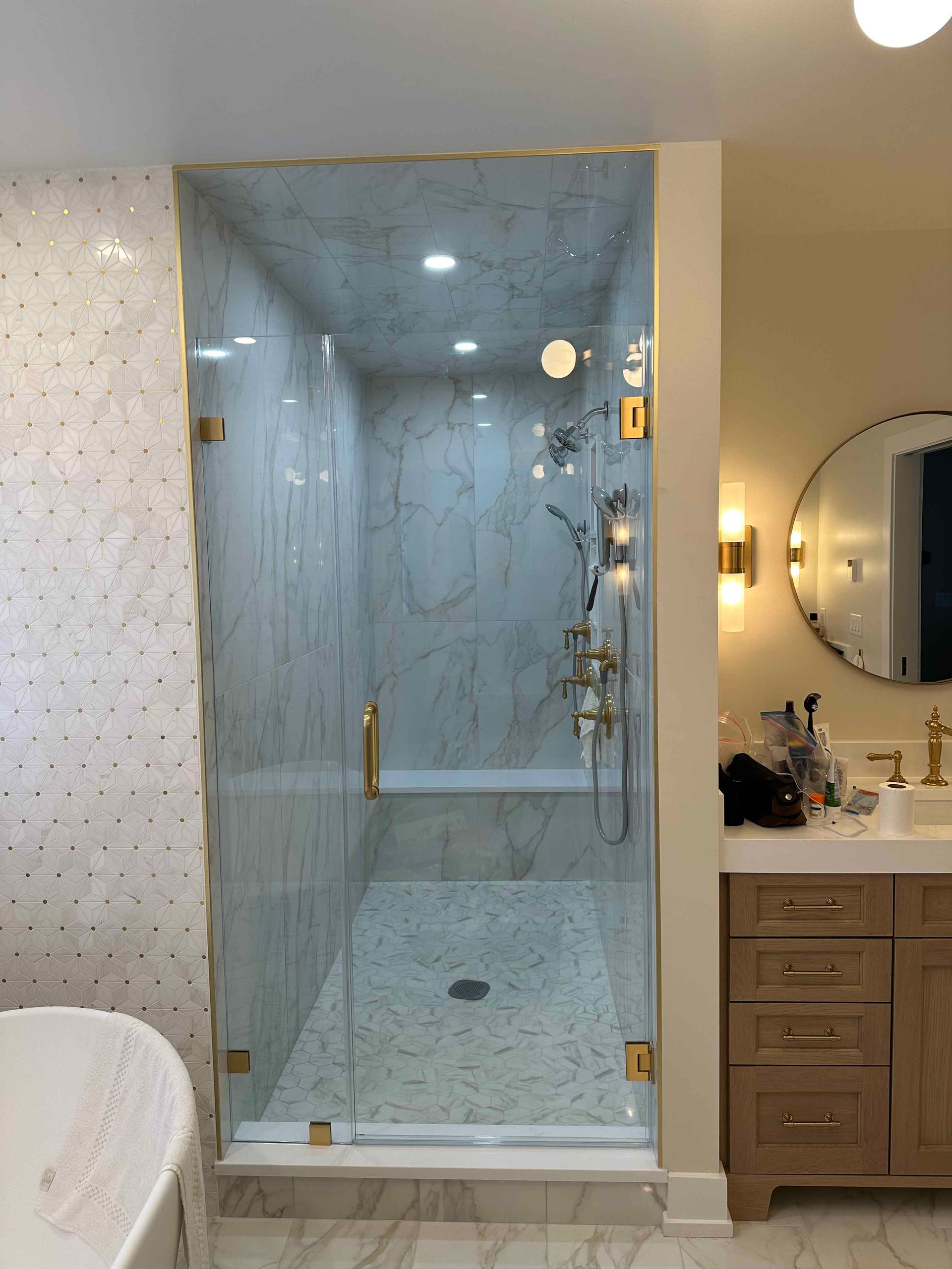 A bathroom with a walk in shower and a bathtub.