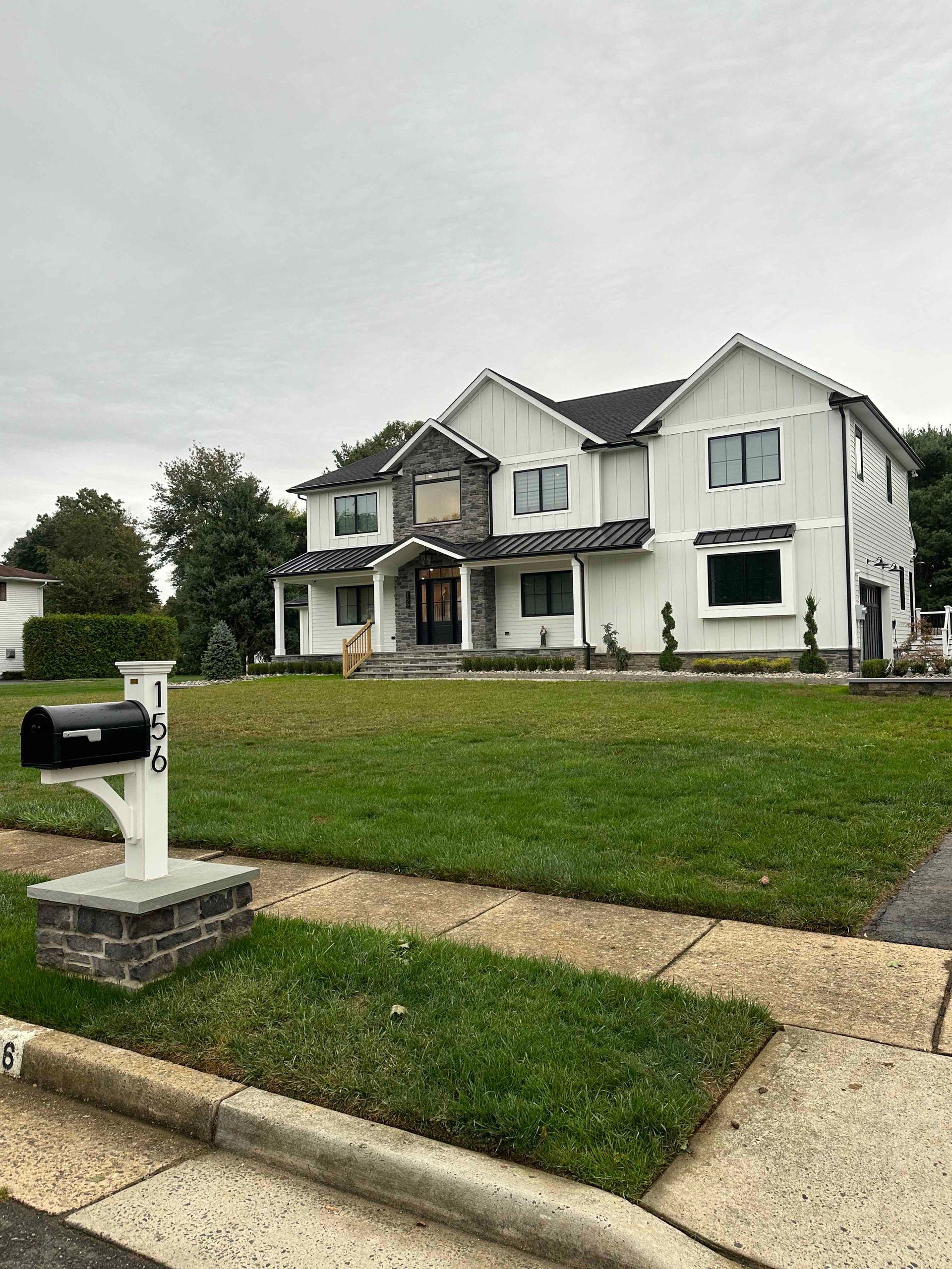 A large white house with a mailbox in front of it.