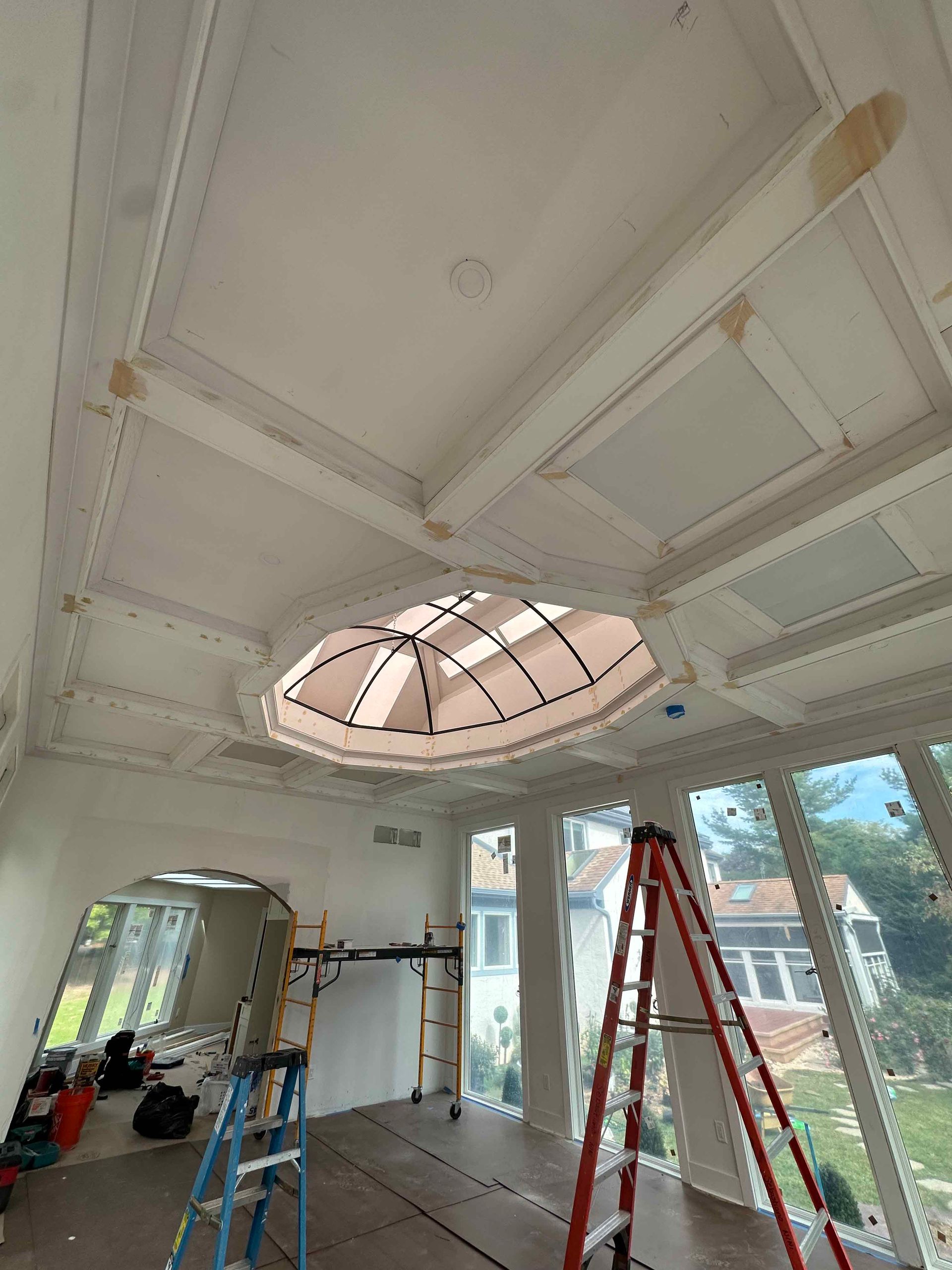 A room with a dome ceiling and a ladder in it.