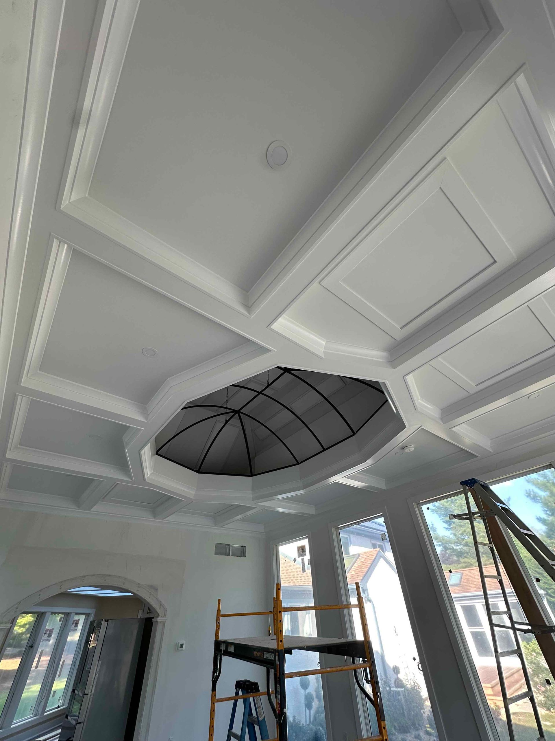 A large room with a ceiling that is being remodeled.