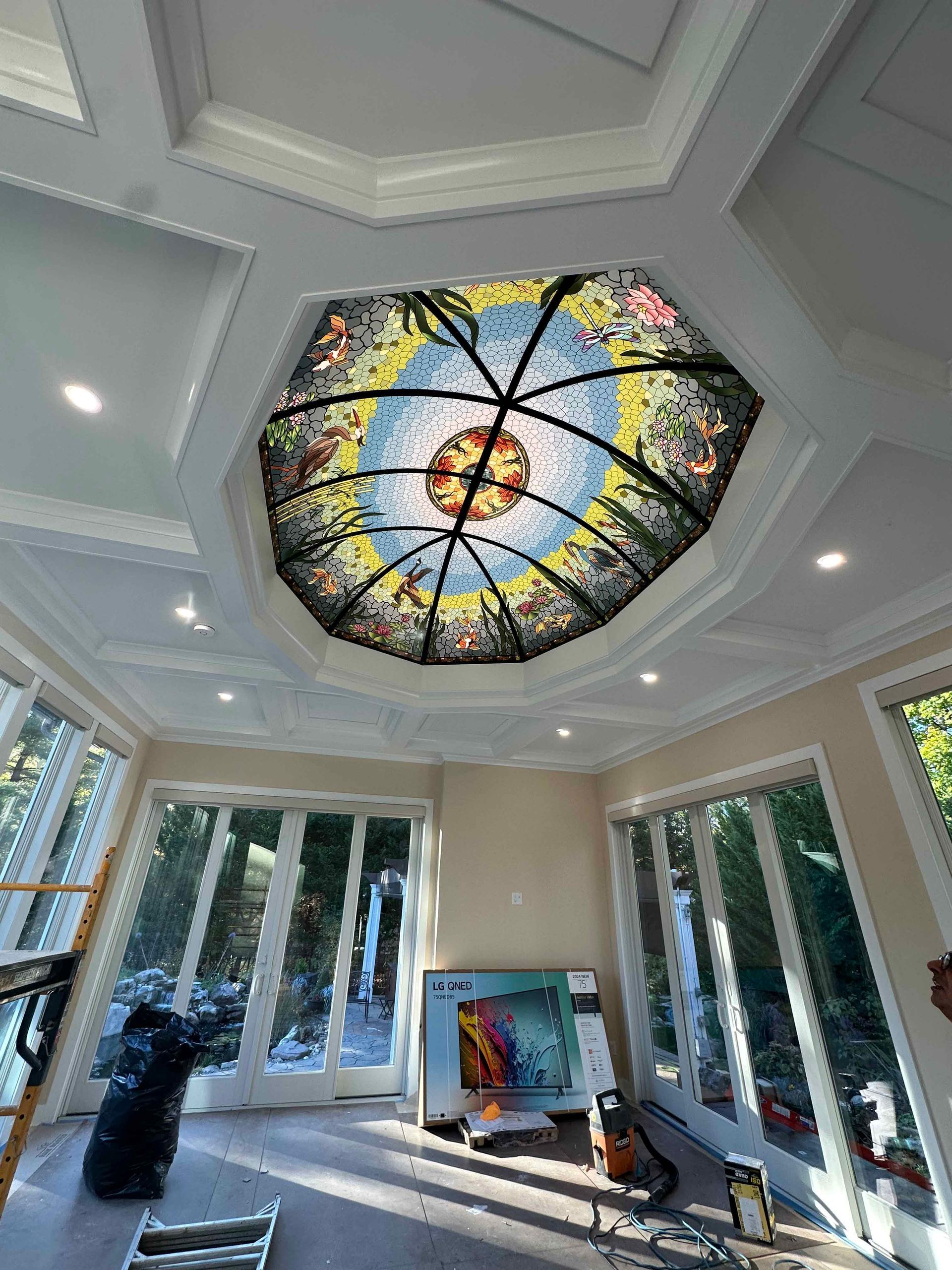 A room with a stained glass dome on the ceiling.
