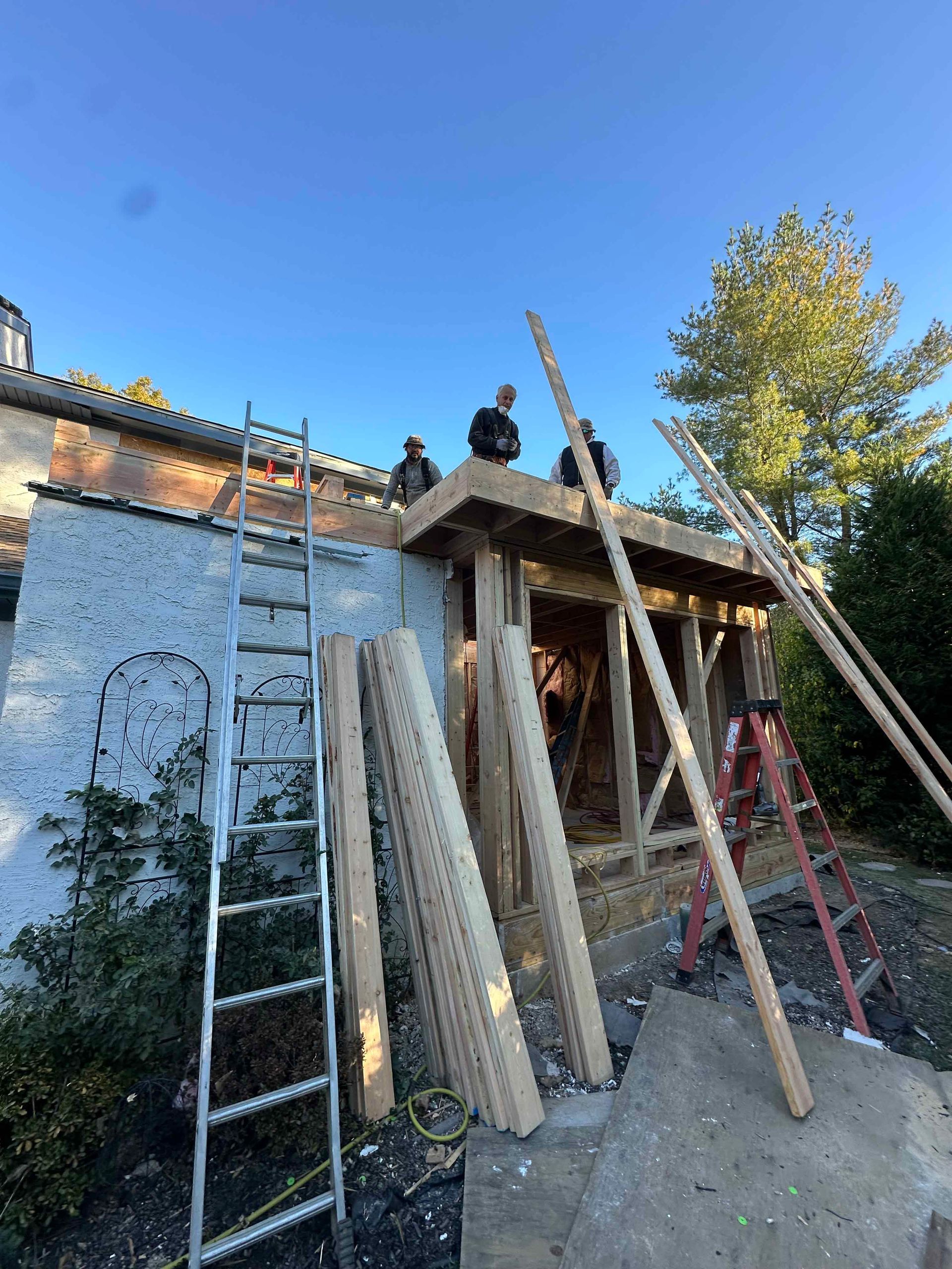 A group of men are working on the roof of a building.