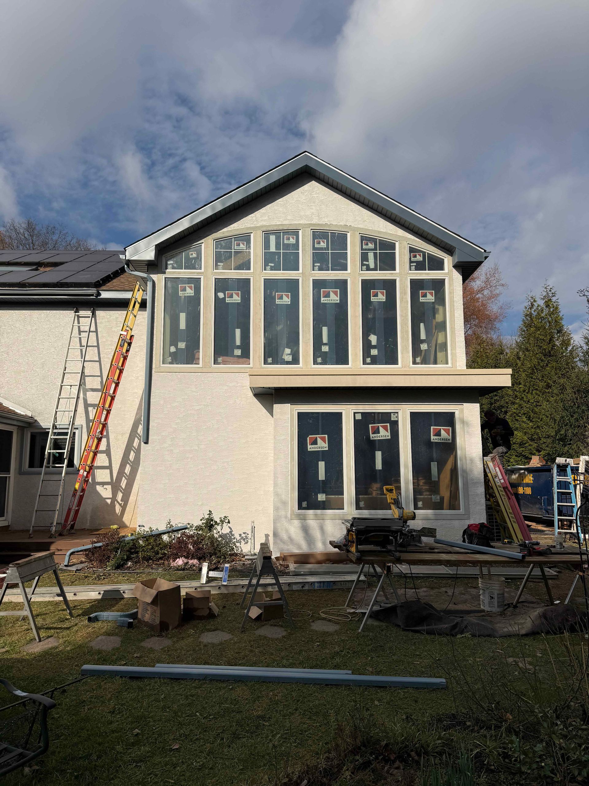 A large house with a lot of windows is being built.