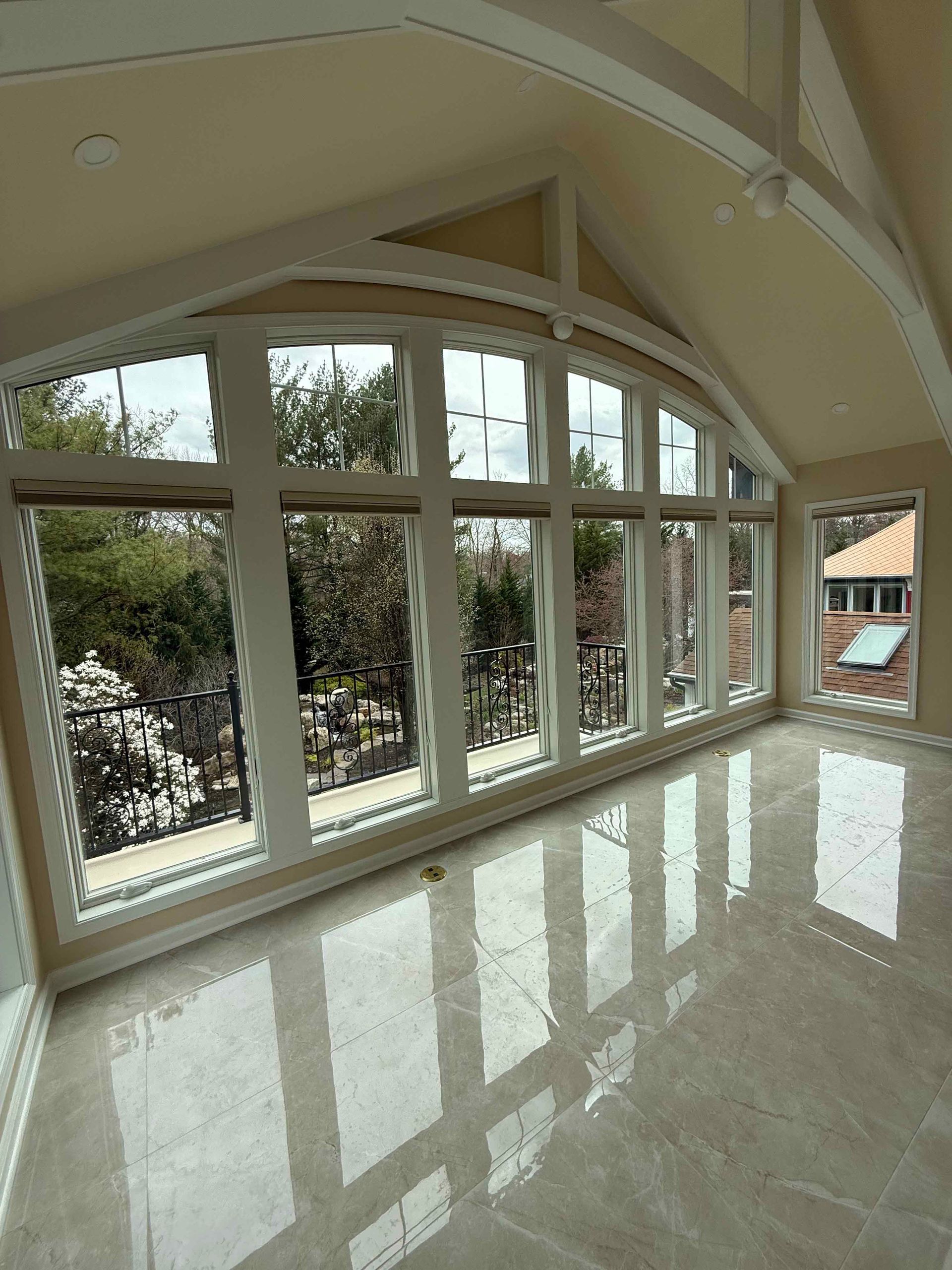 A room with a lot of windows and a balcony