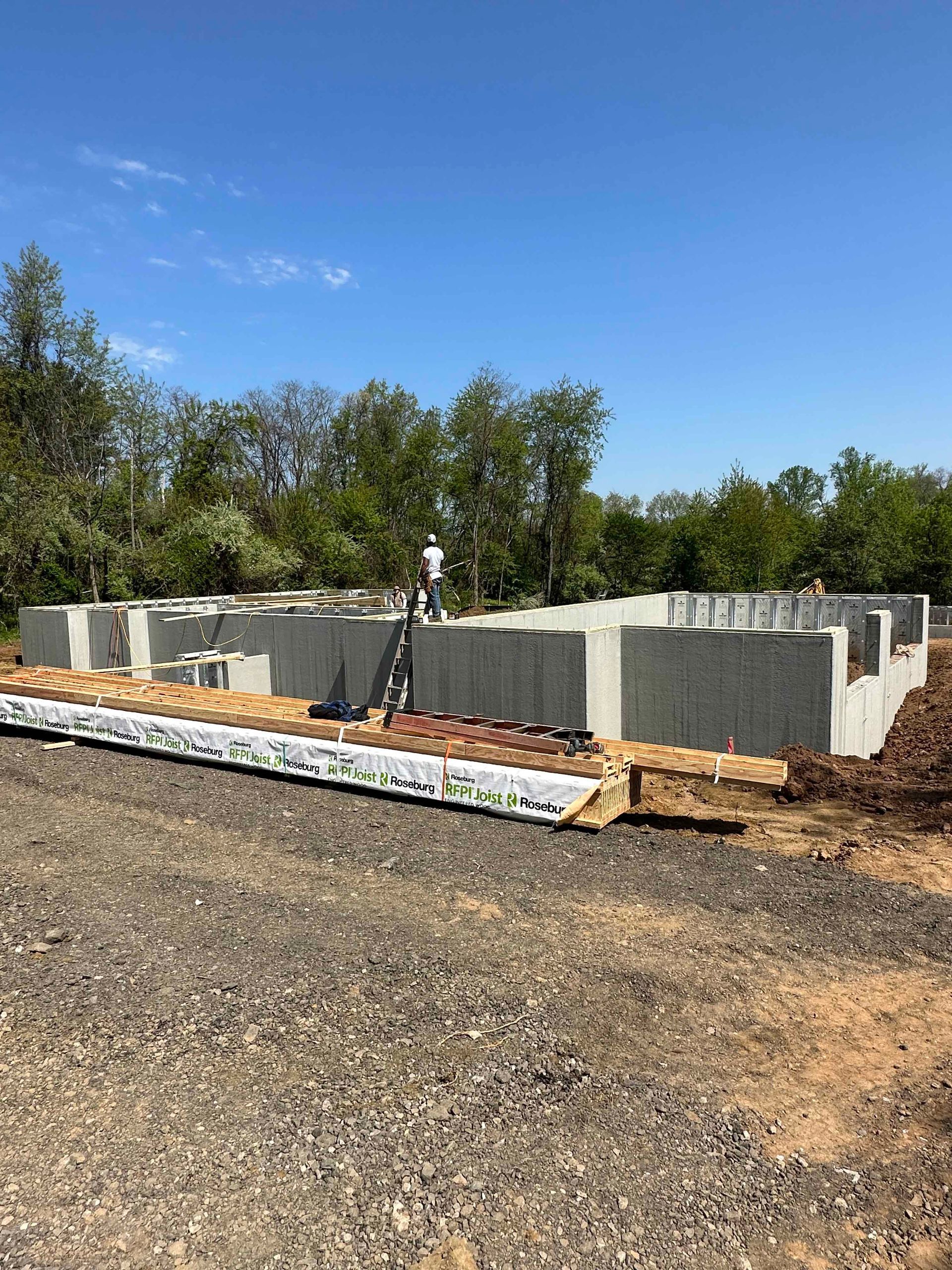 A man is standing on top of a concrete foundation.
