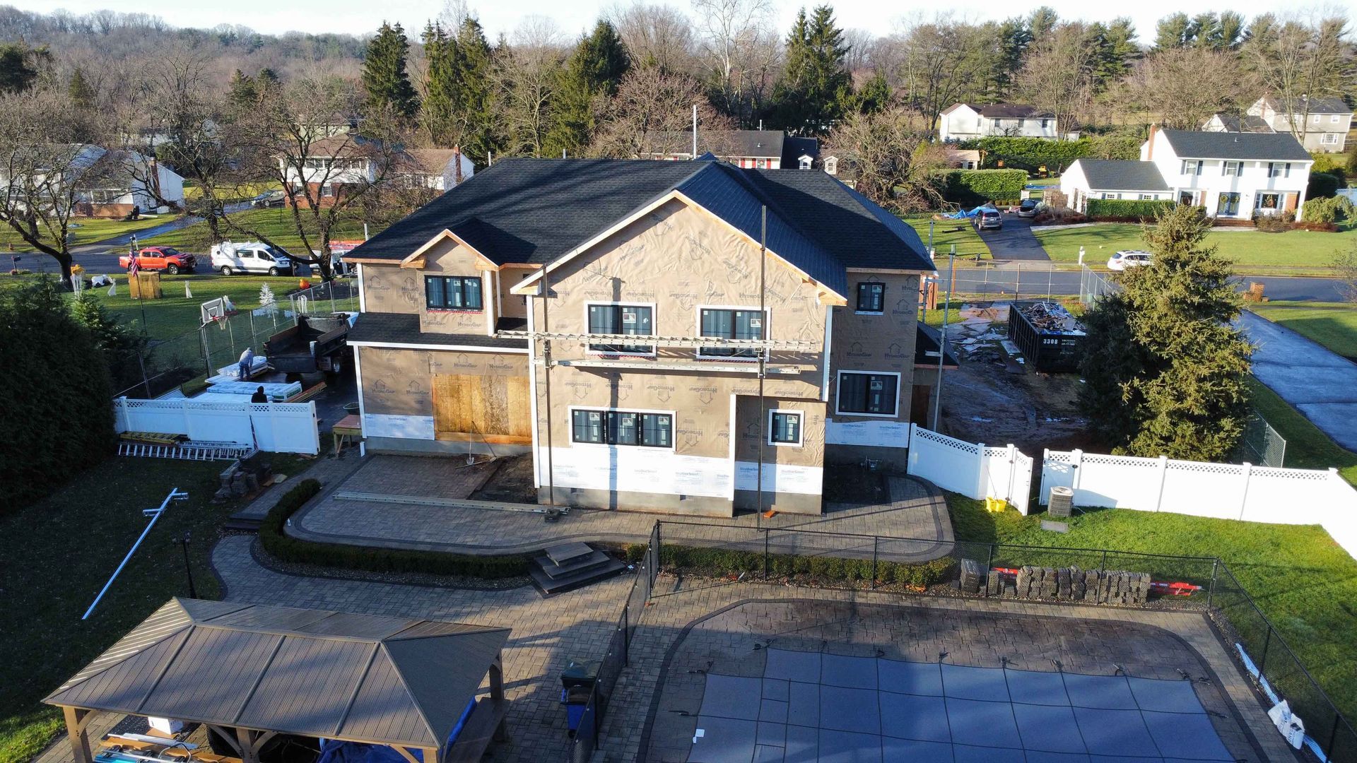 An aerial view of a large house with a pool in the backyard