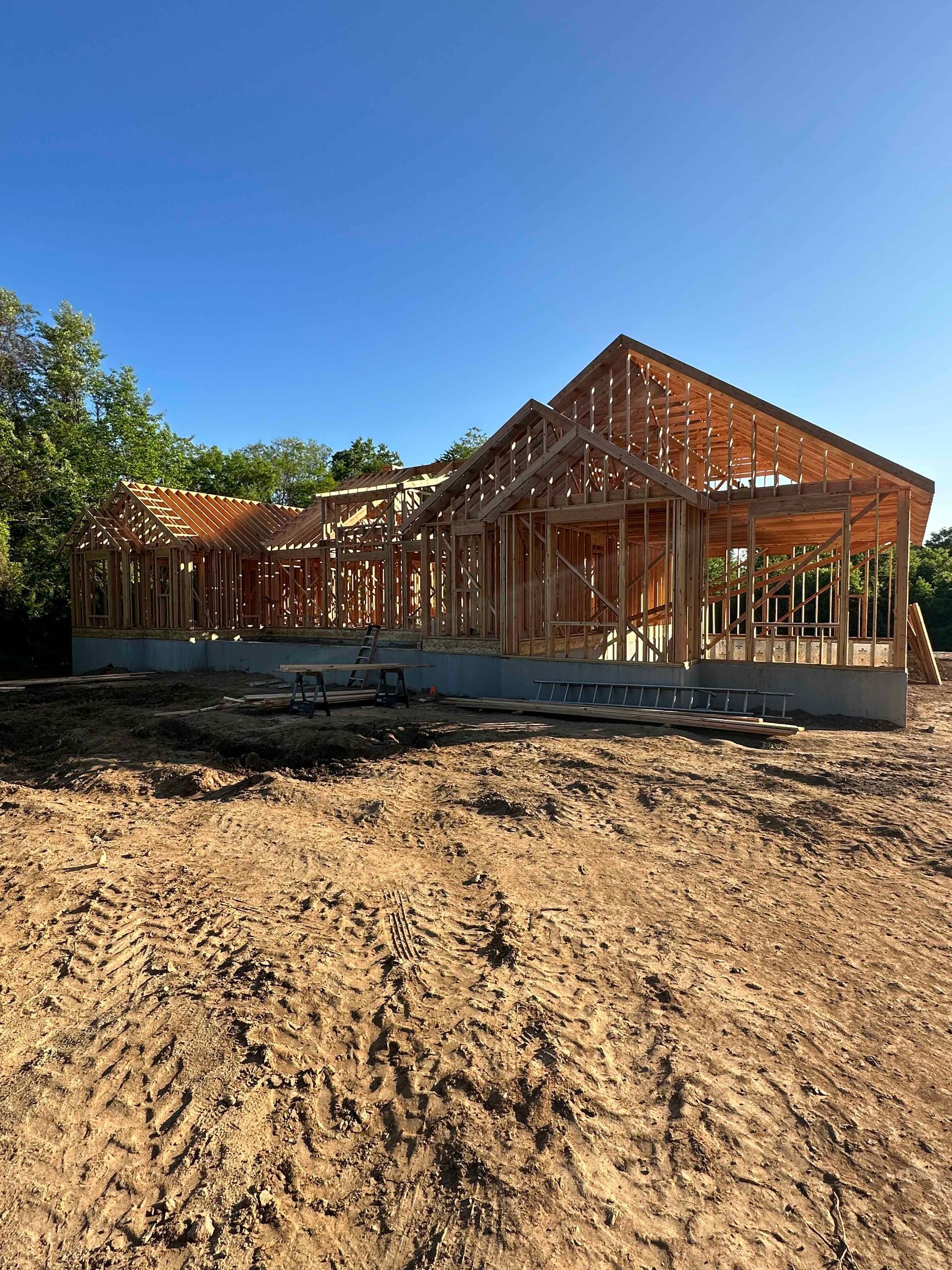 A house is being built in a dirt field.