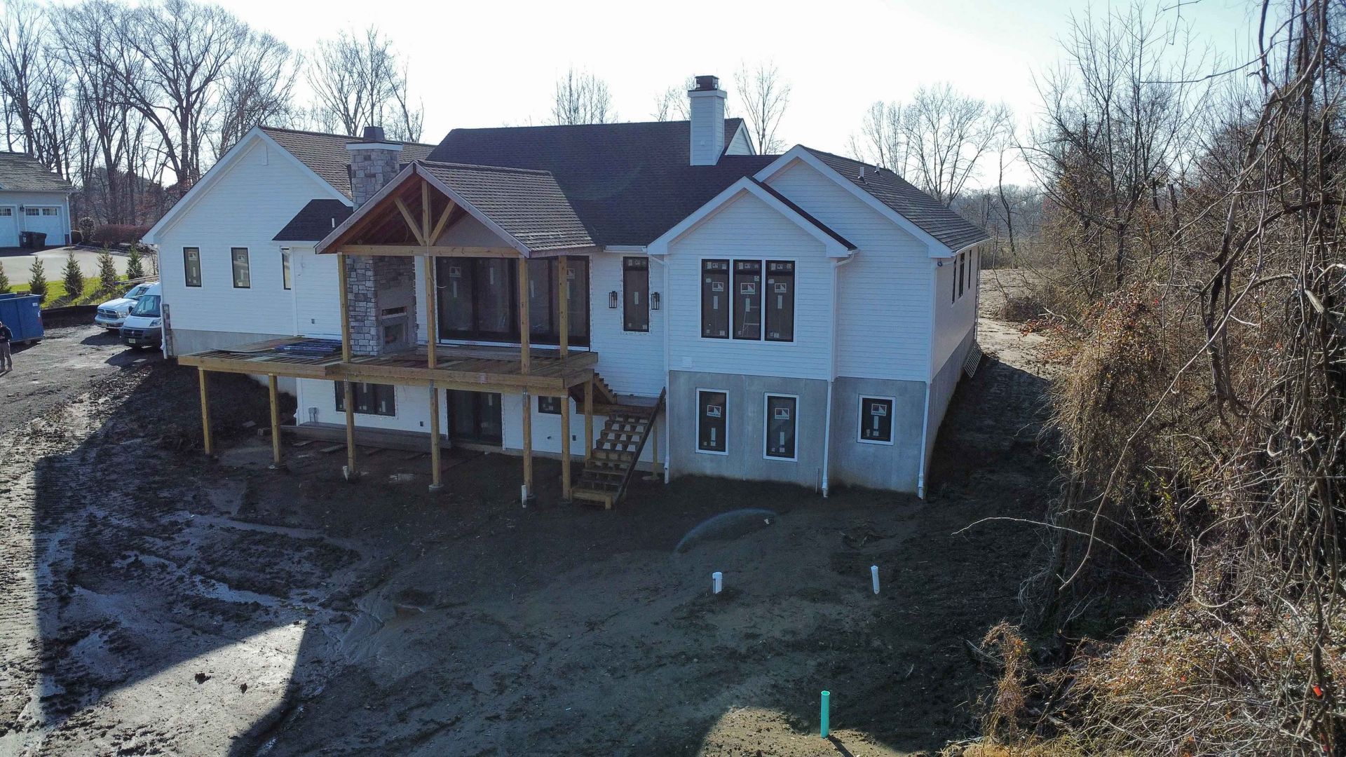An aerial view of a house under construction with a large deck
