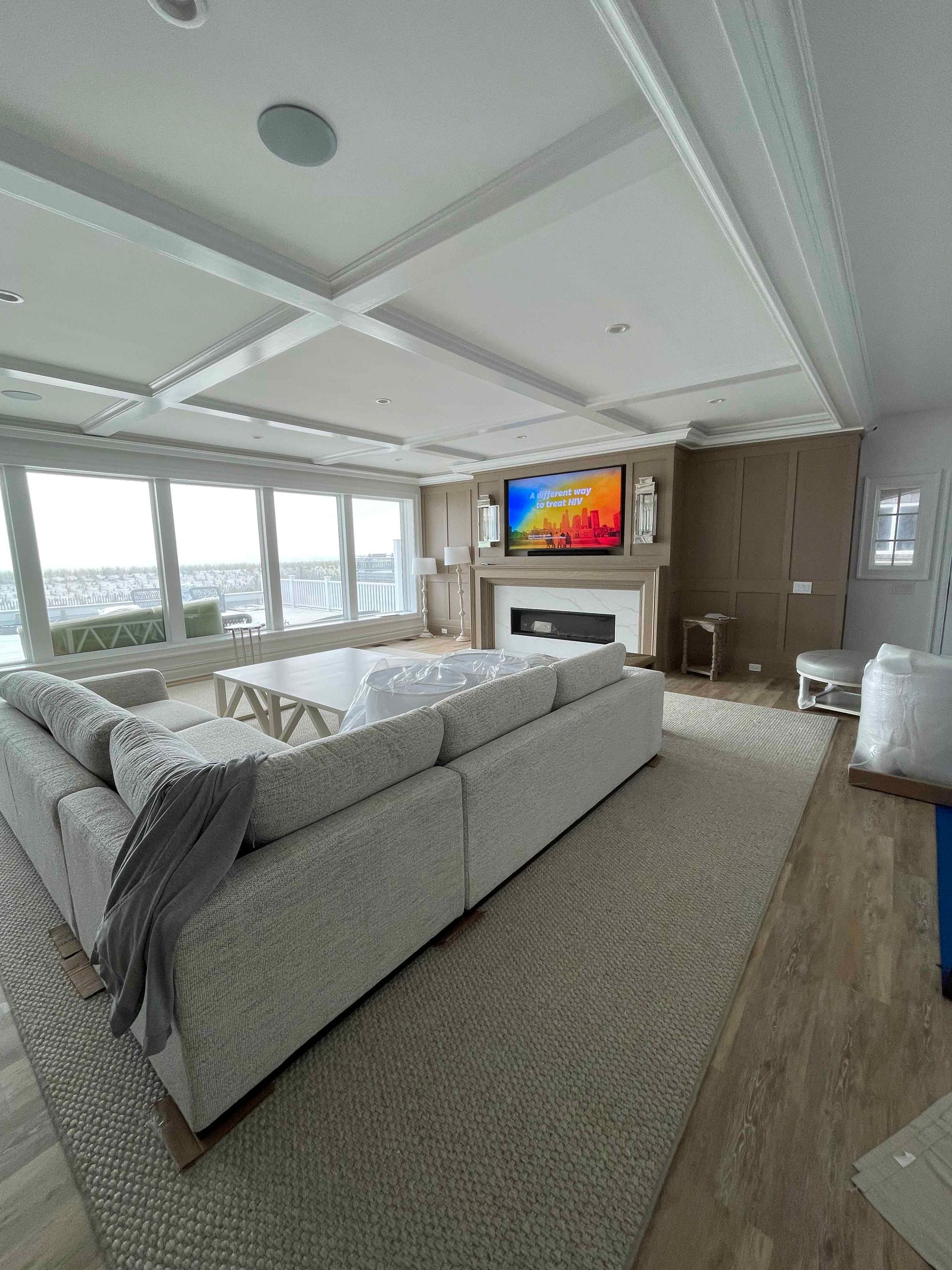 A living room with a couch , fireplace and television.
