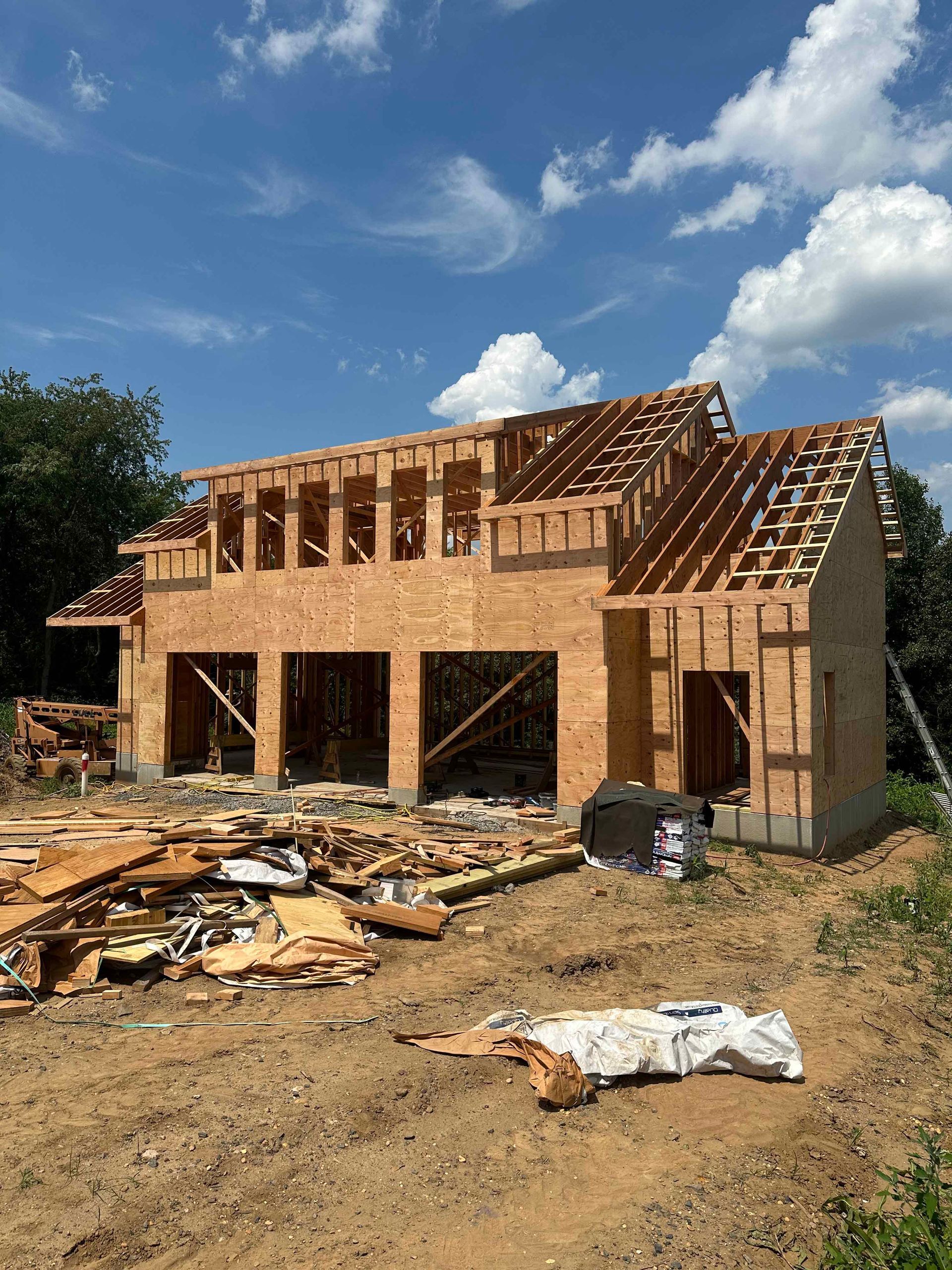 A house is being built in the middle of a dirt field.