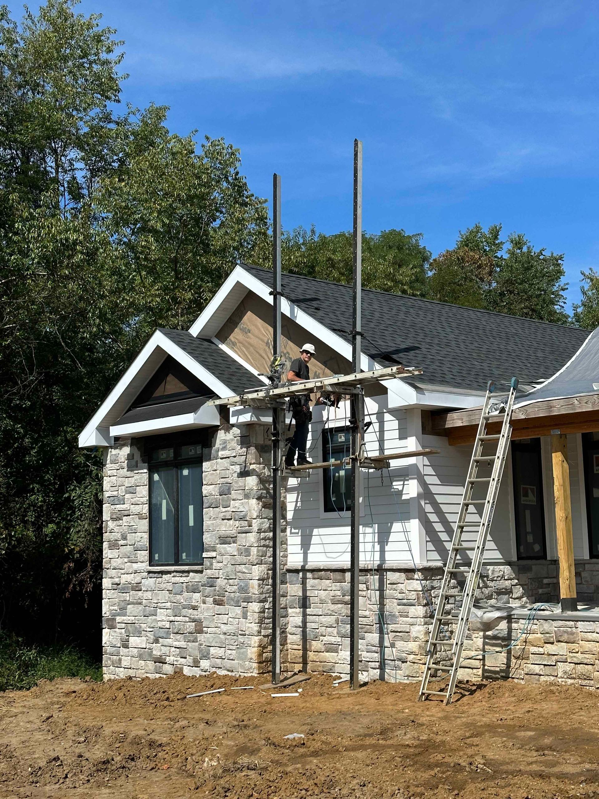 A house under construction with a ladder in front of it