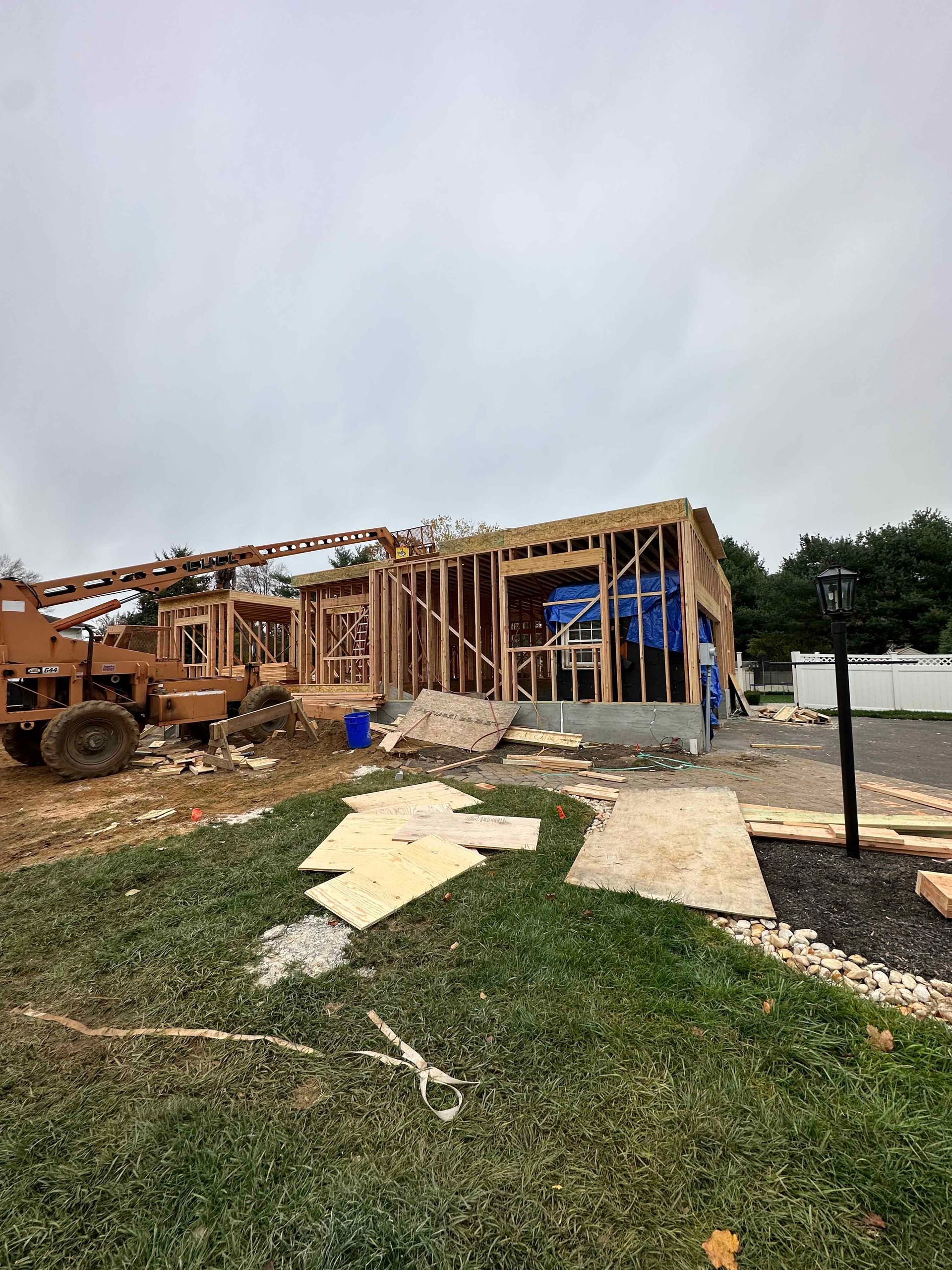 A house is being built with a crane in the background.