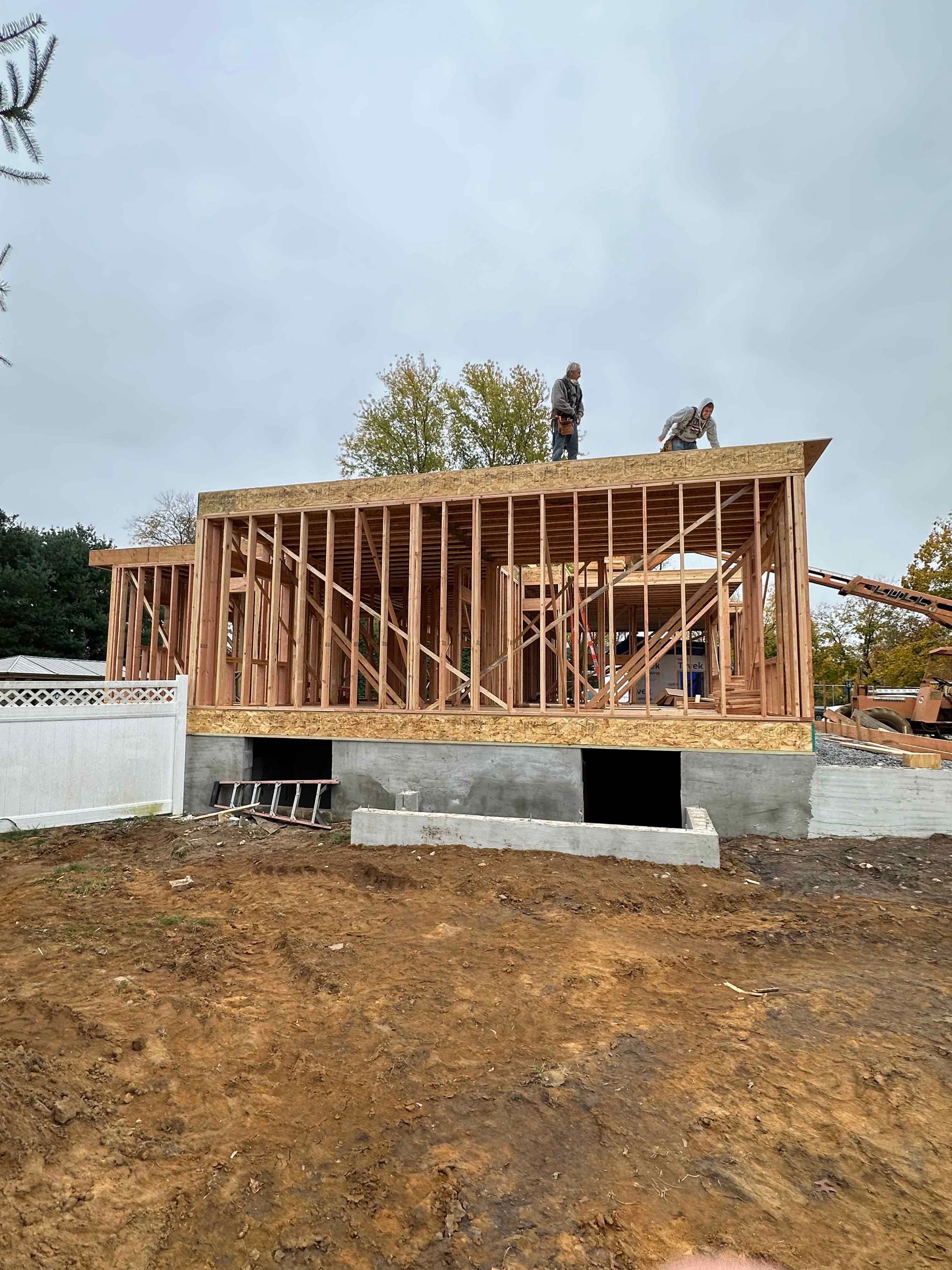 A house is being built in a dirt field.