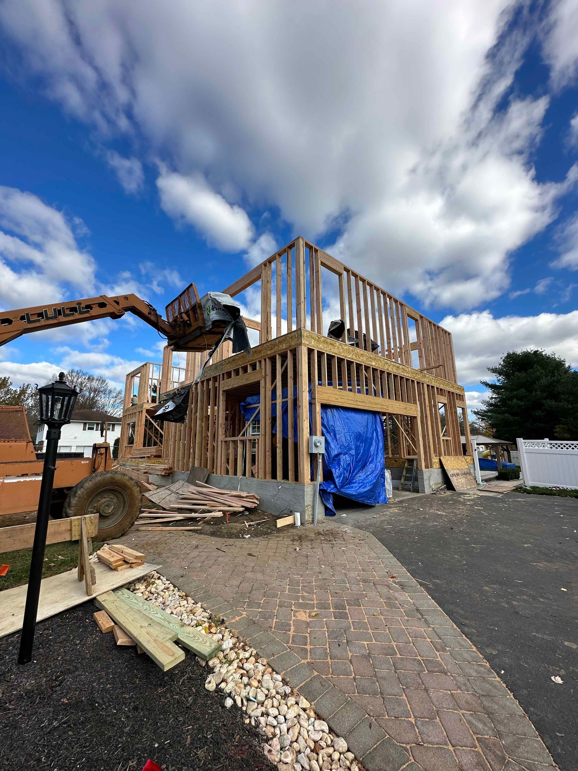 A house is being built with a crane in the background.