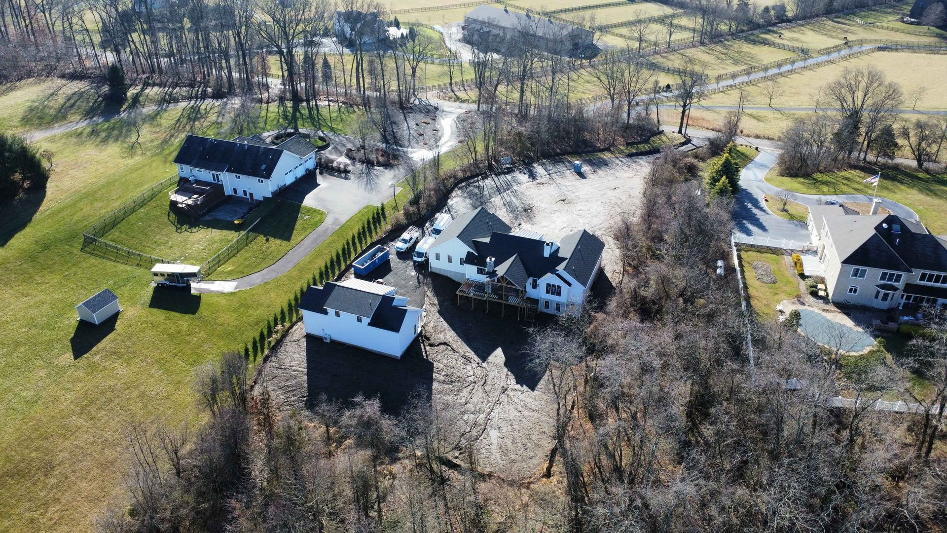 An aerial view of a residential area with a lot of houses and trees.