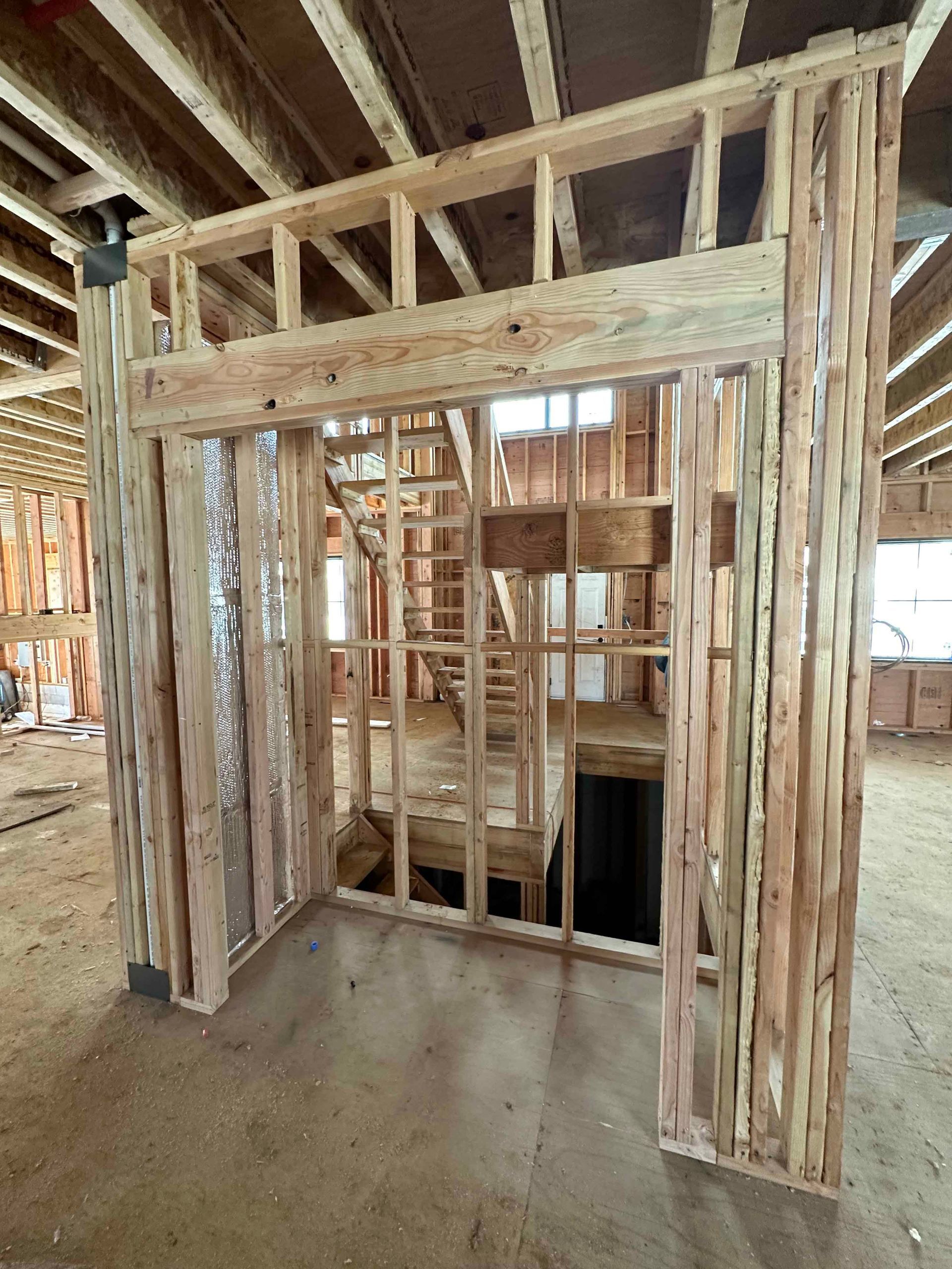 A room in a house under construction with a wooden frame.