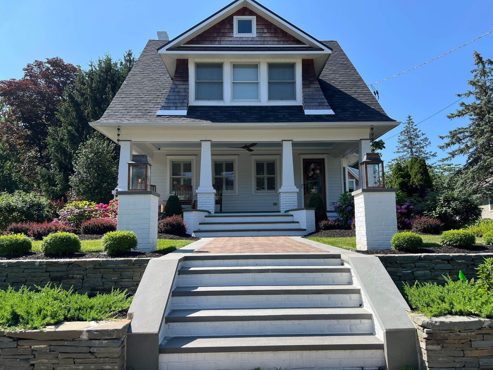 A white house with stairs leading up to the front door