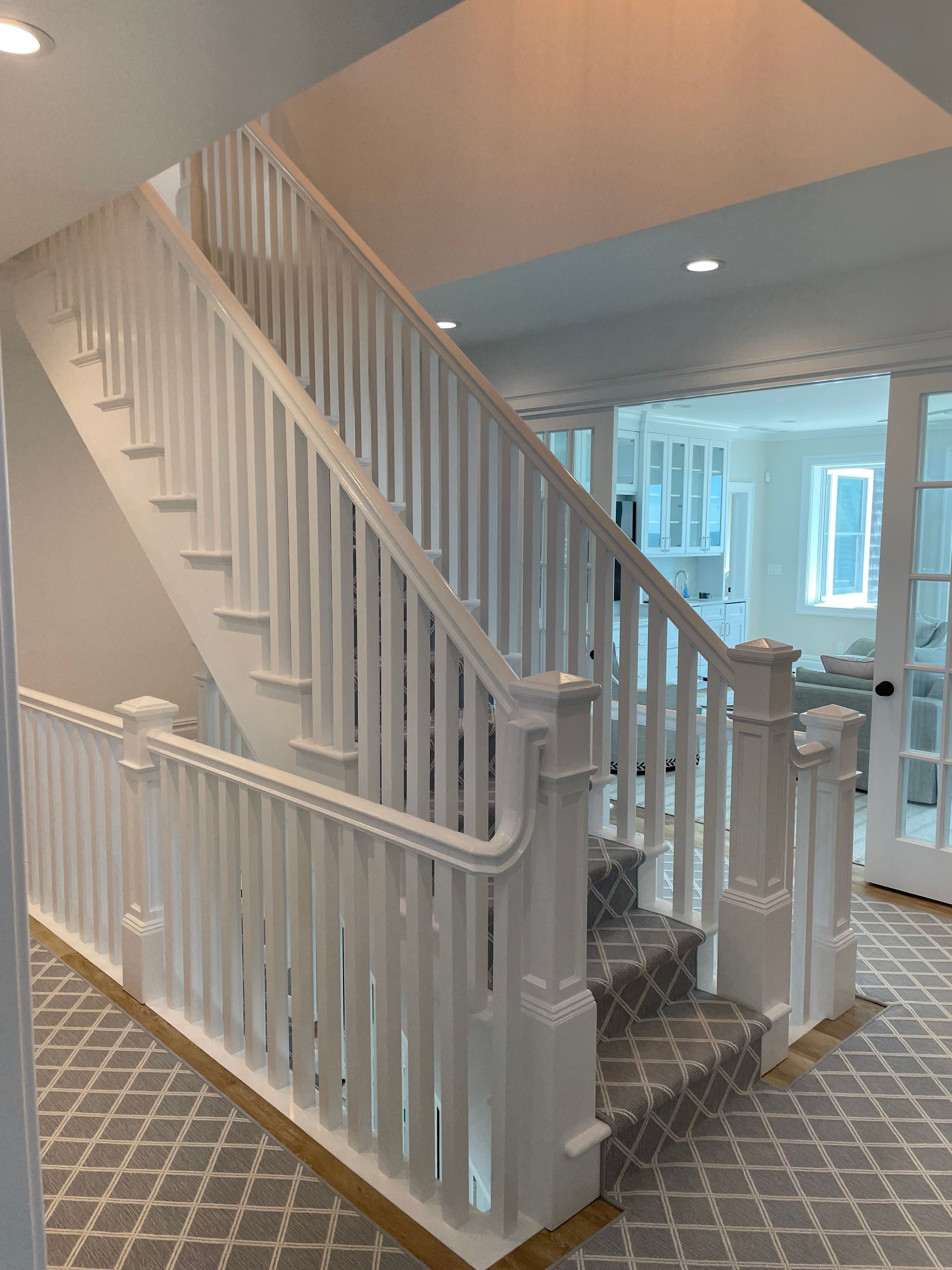 A staircase in a house with a white railing