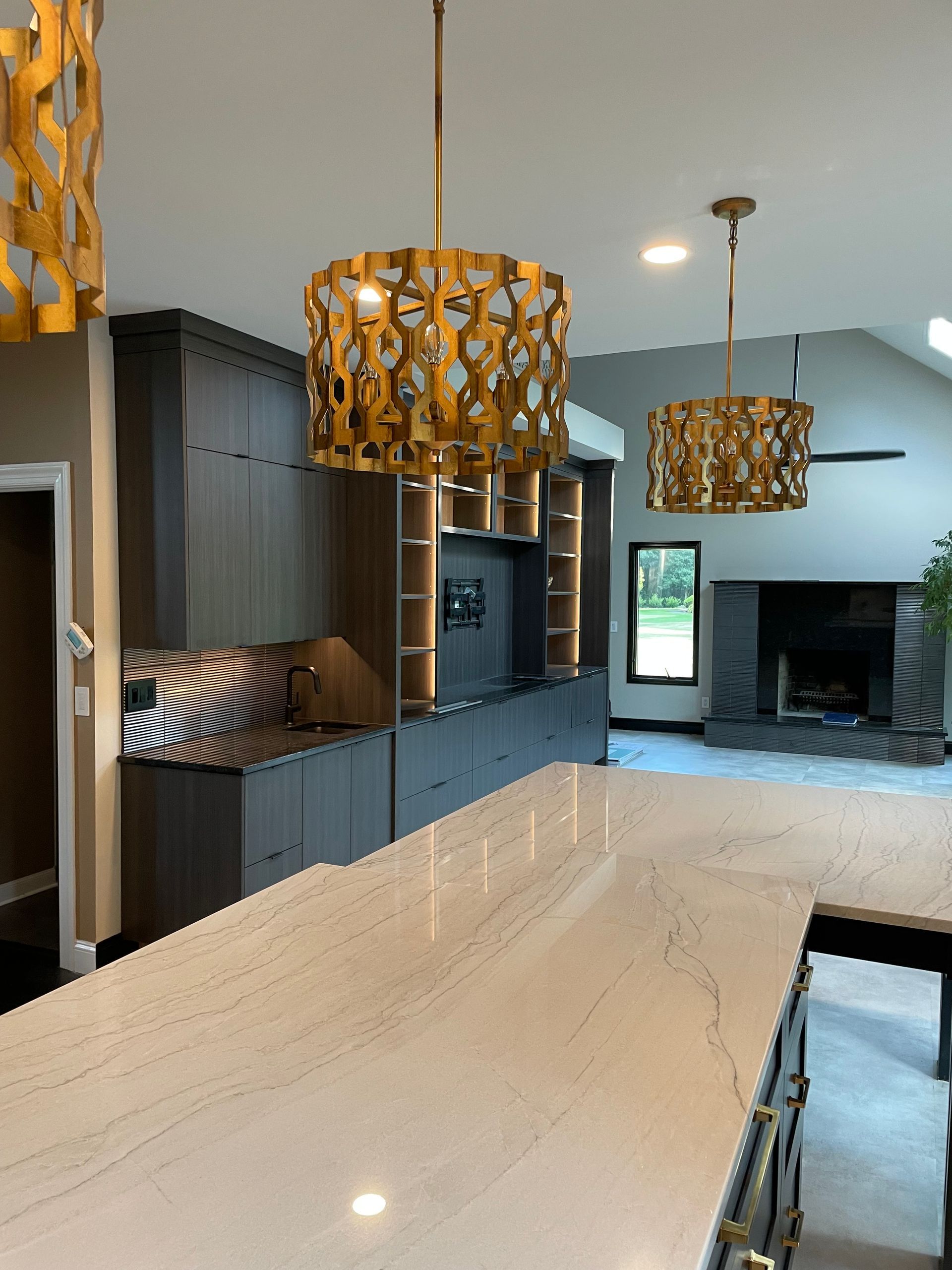 A kitchen with a large island and a fireplace
