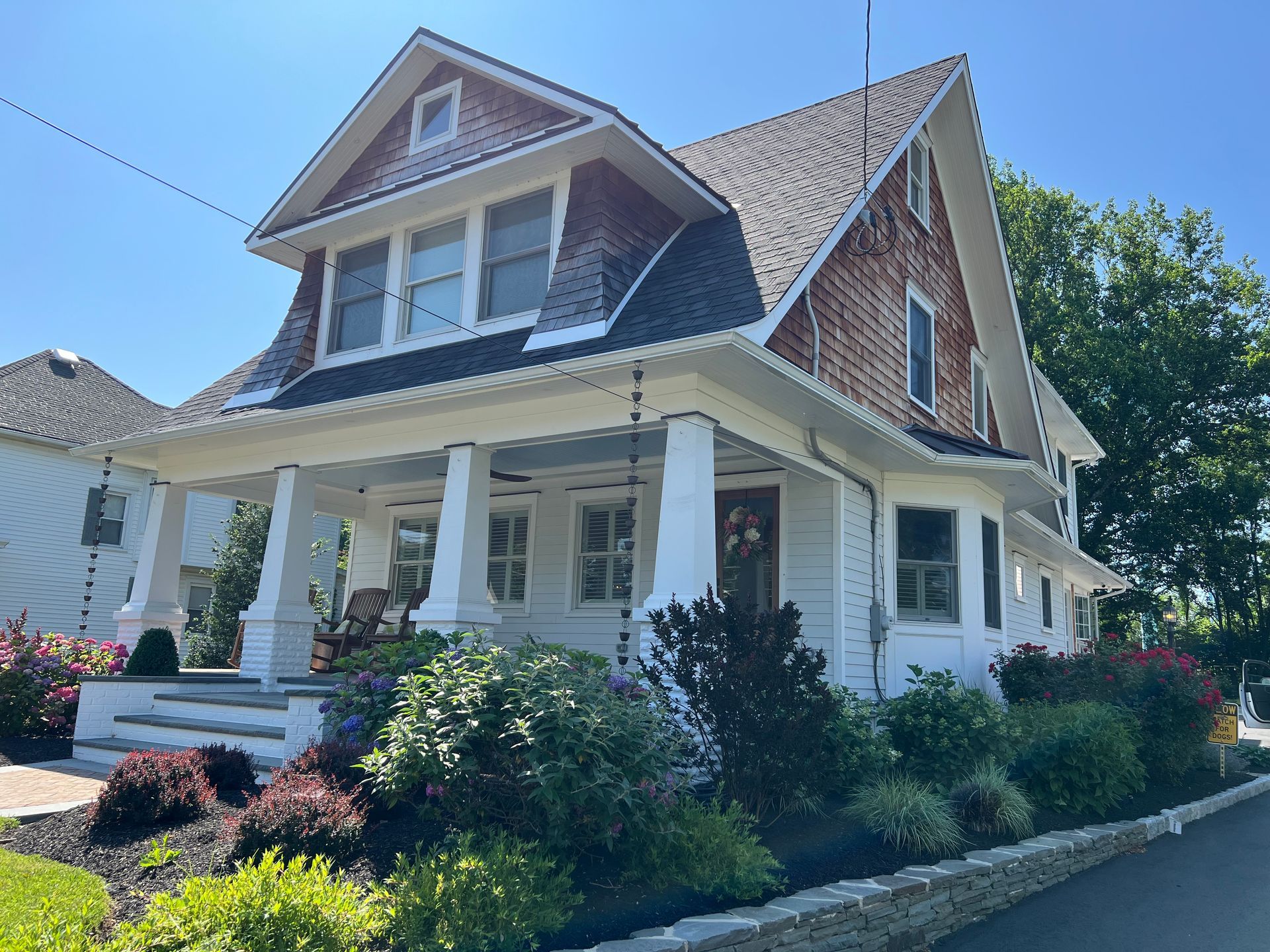 A large white house with a porch and a roof