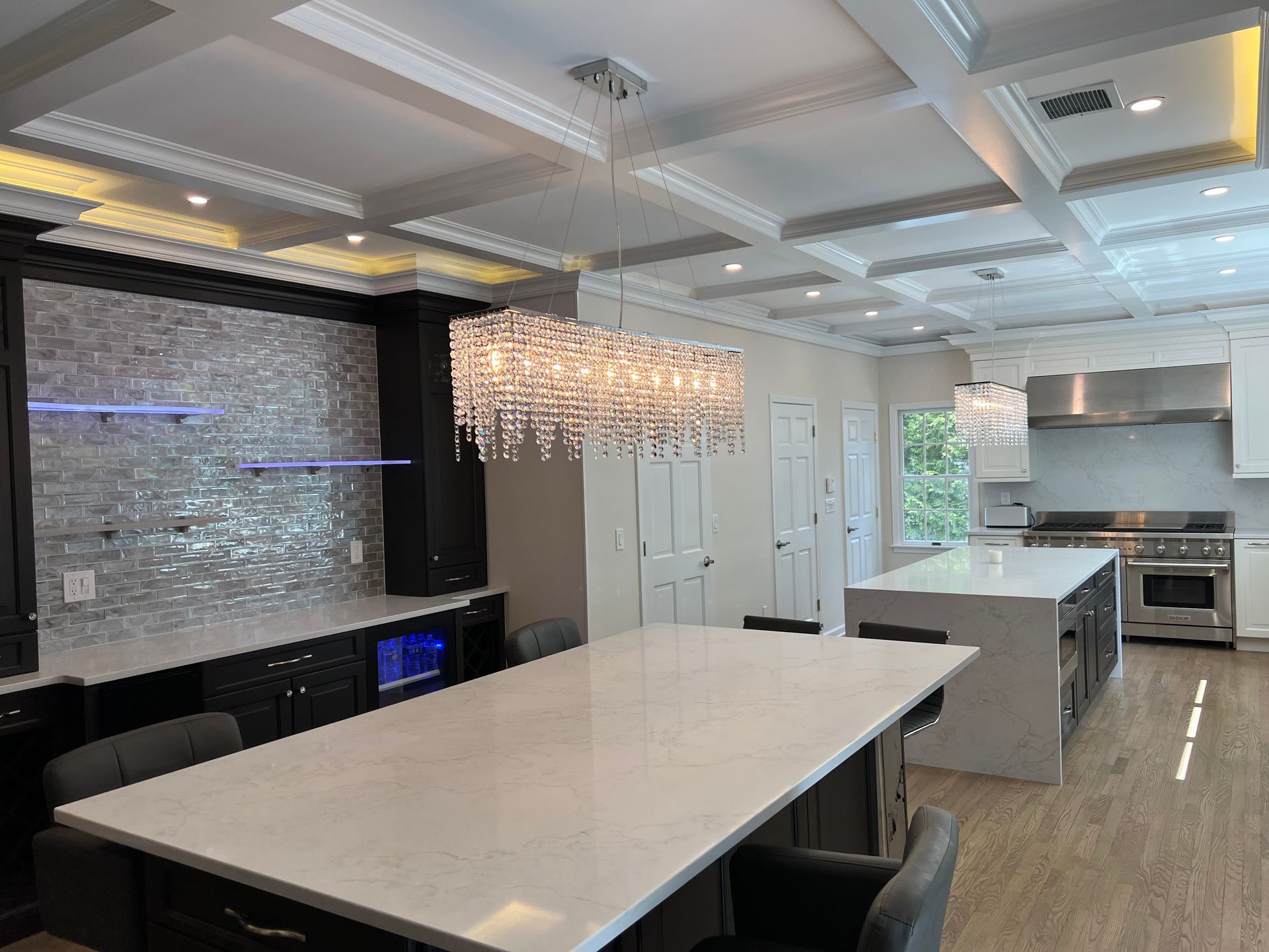 A kitchen with a large table and chairs and a chandelier hanging from the ceiling