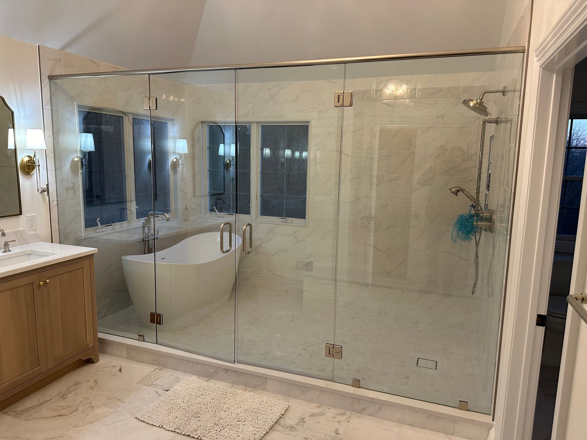 A bathroom with a walk in shower and a bathtub