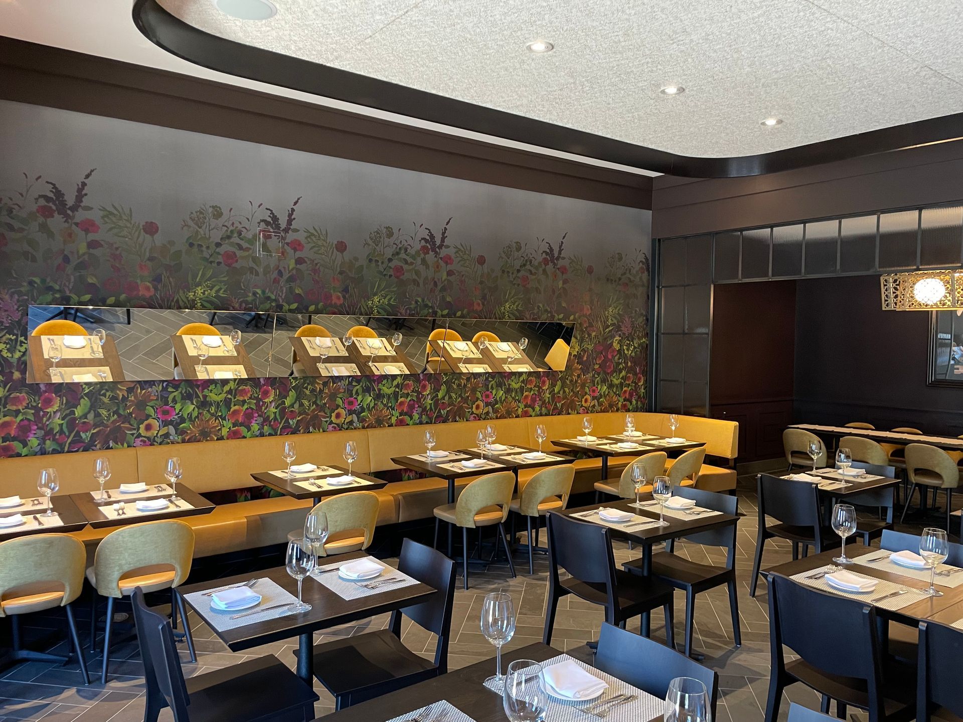 A restaurant with tables and chairs set up for dinner