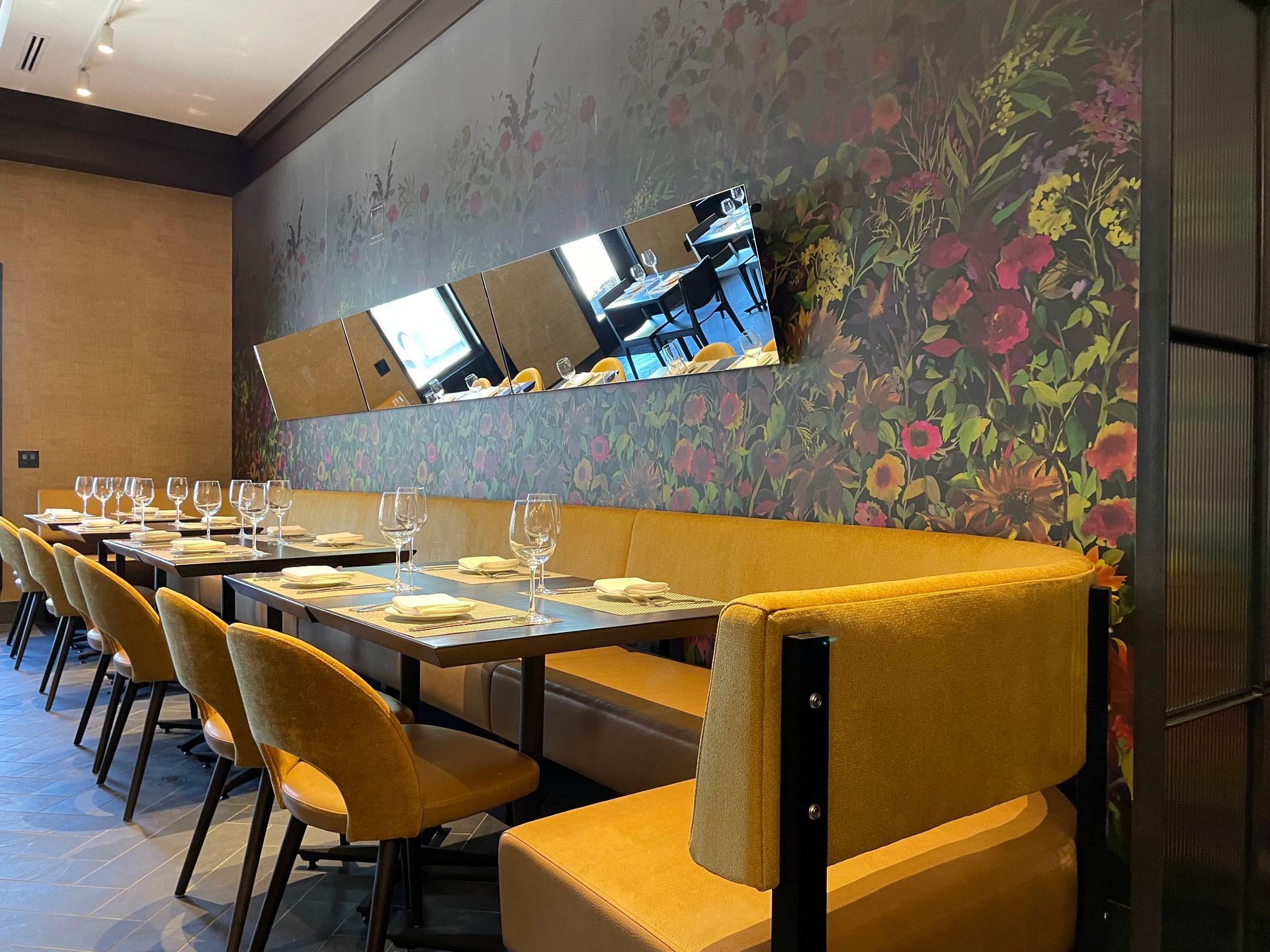 A restaurant with tables and chairs set up for dinner
