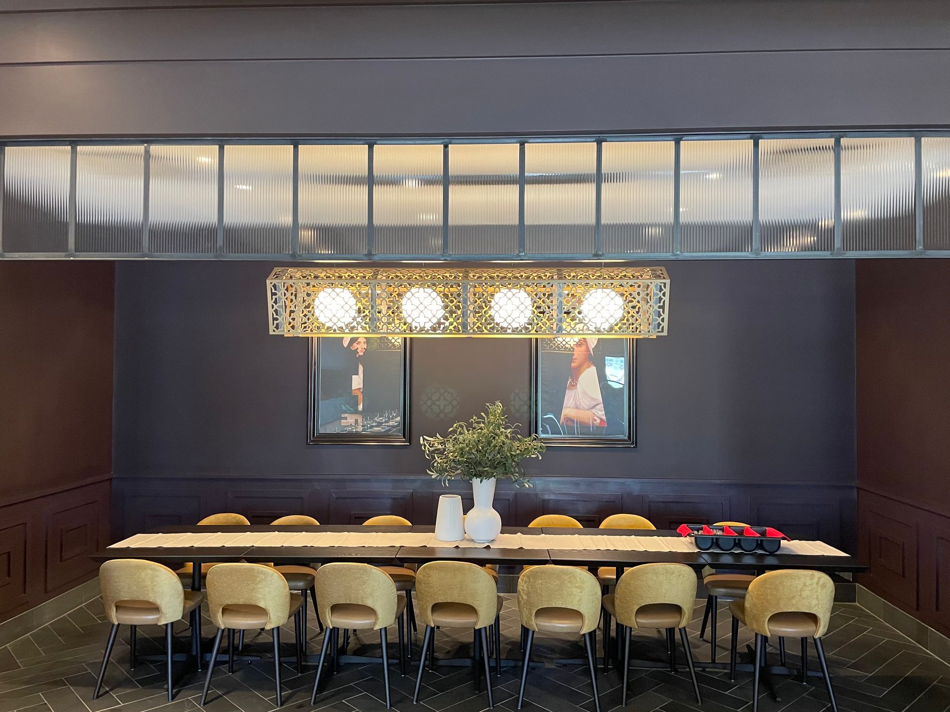A large dining room with a long table and chairs.