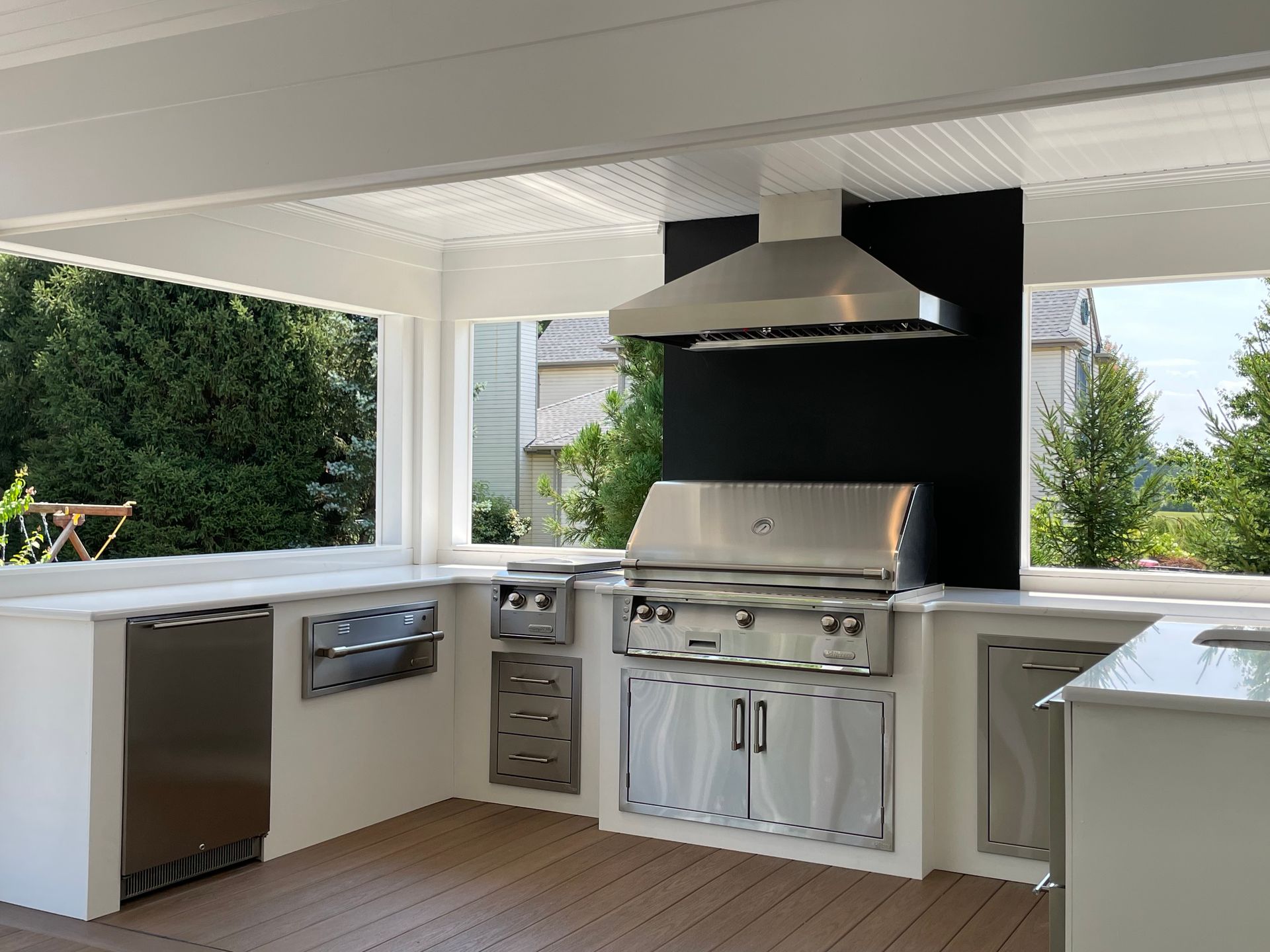 A kitchen with stainless steel appliances and a grill